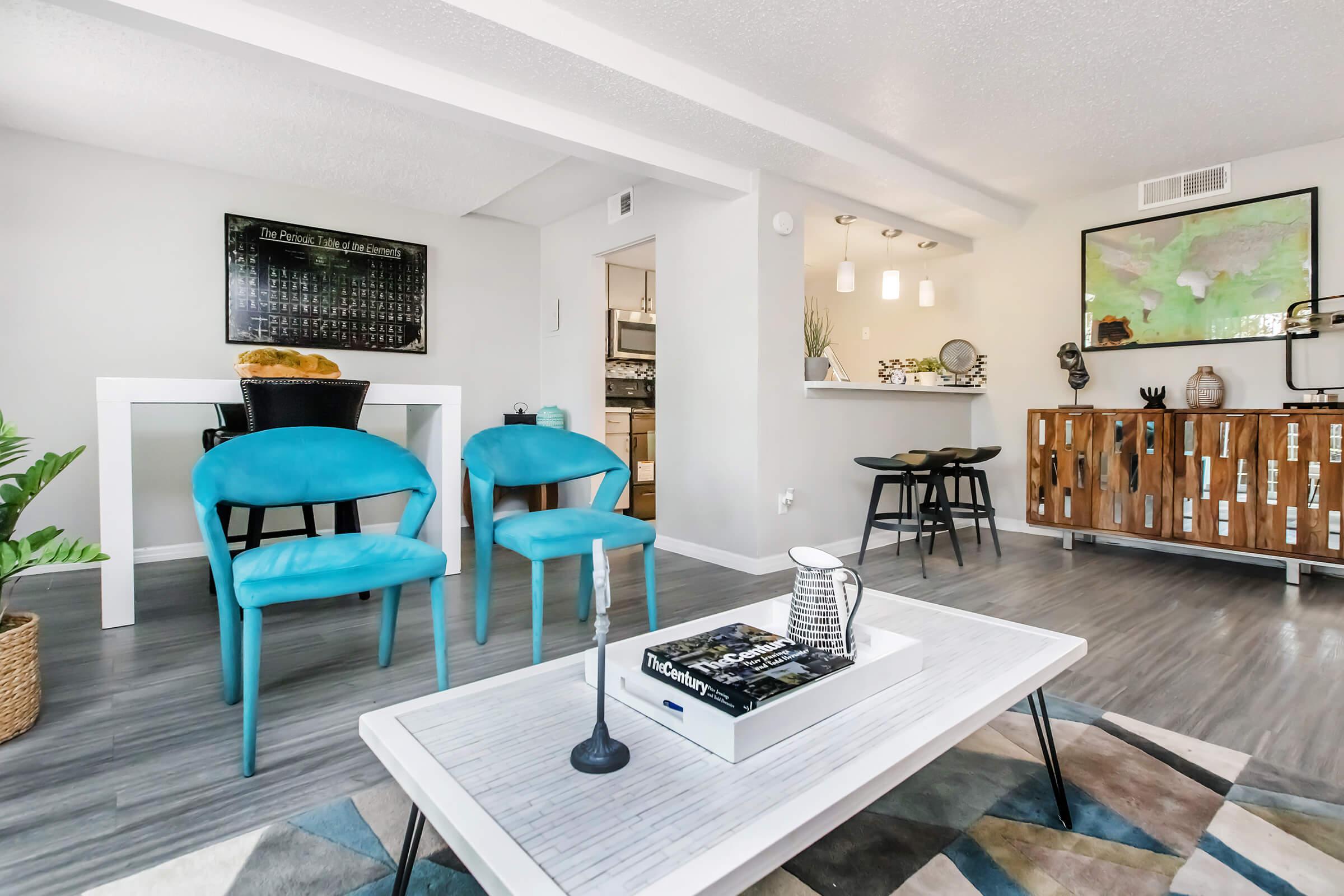 a living room filled with furniture and a table