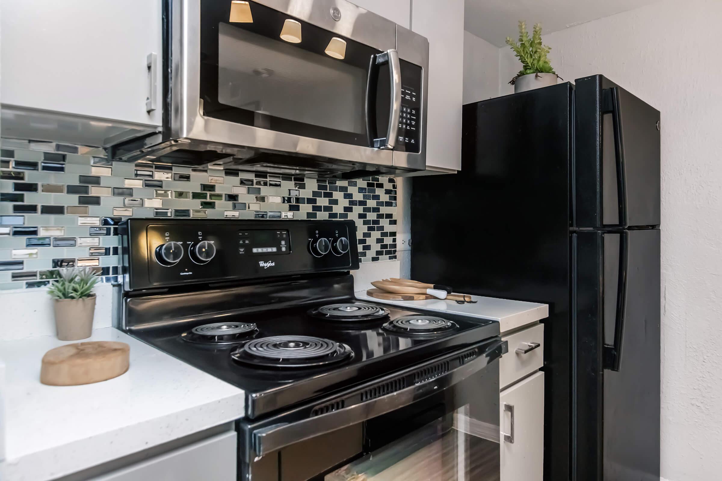 a stove top oven sitting inside of a kitchen