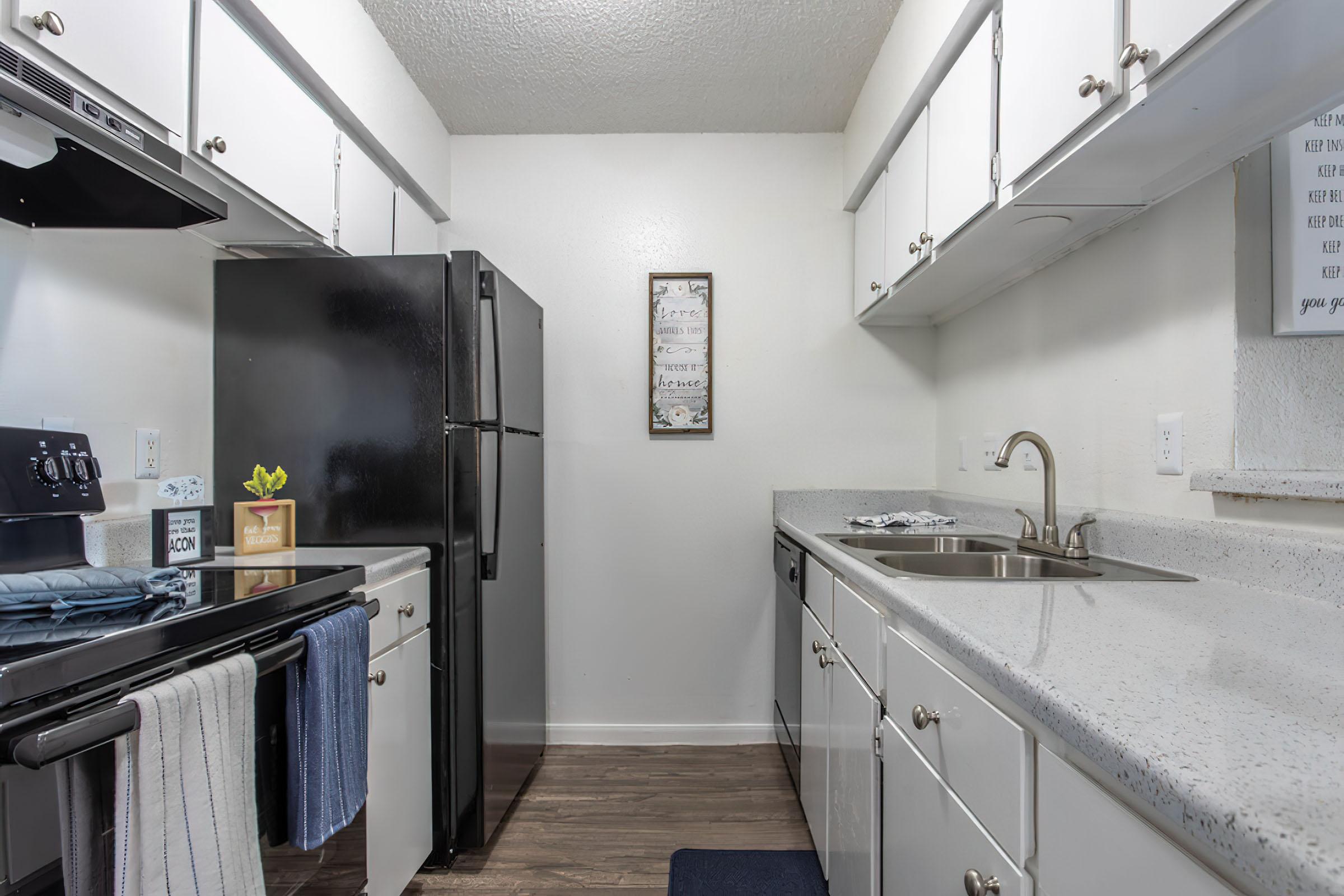 a kitchen with a sink and a mirror