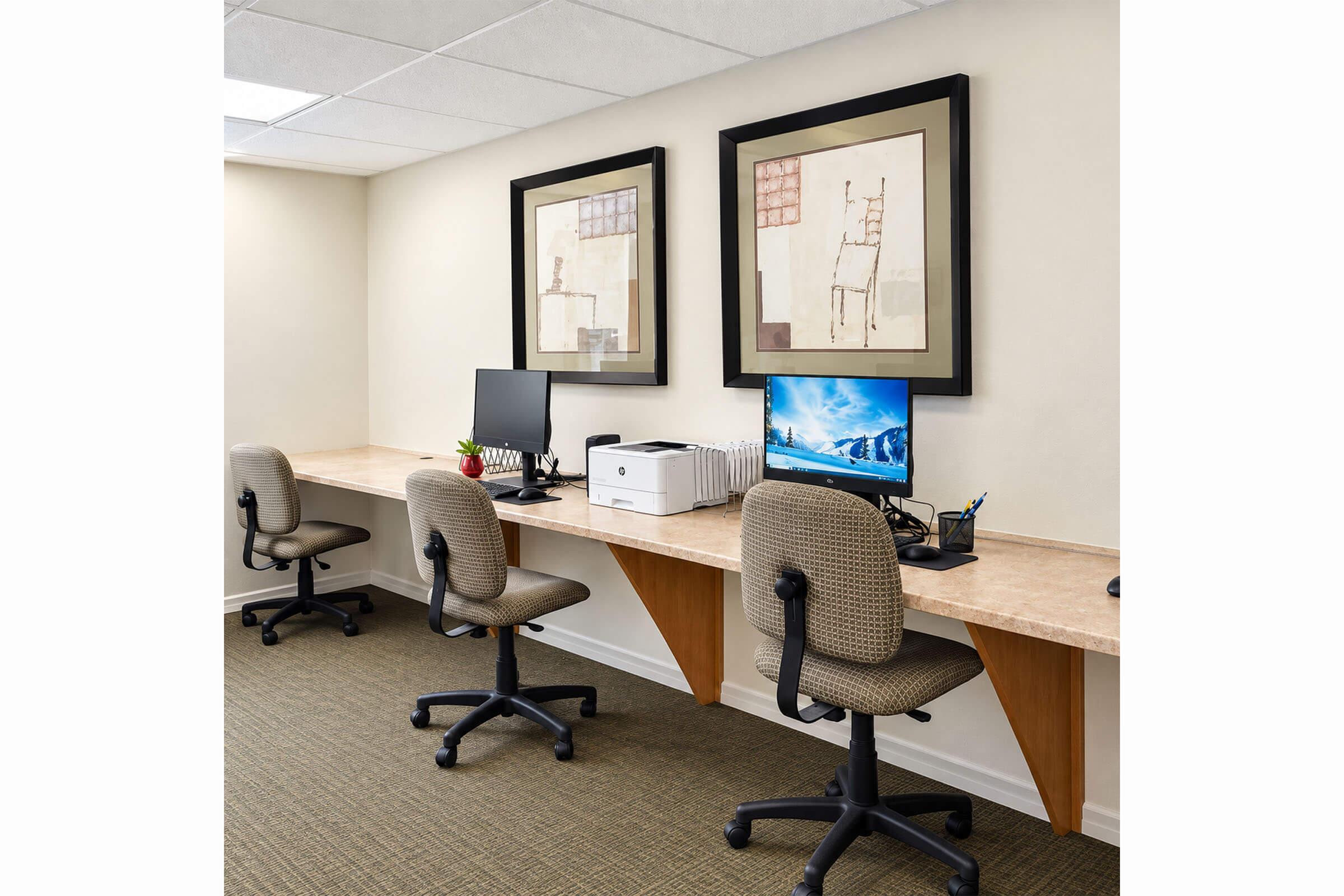 Business center with computers and a printer.