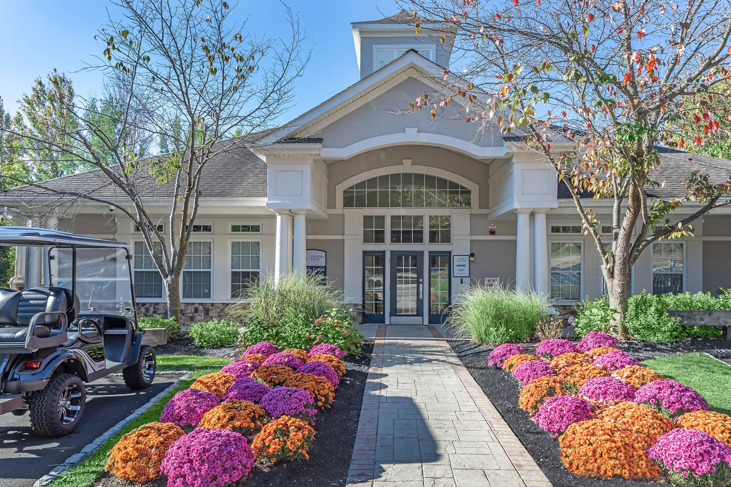 a colorful flower garden in front of a building