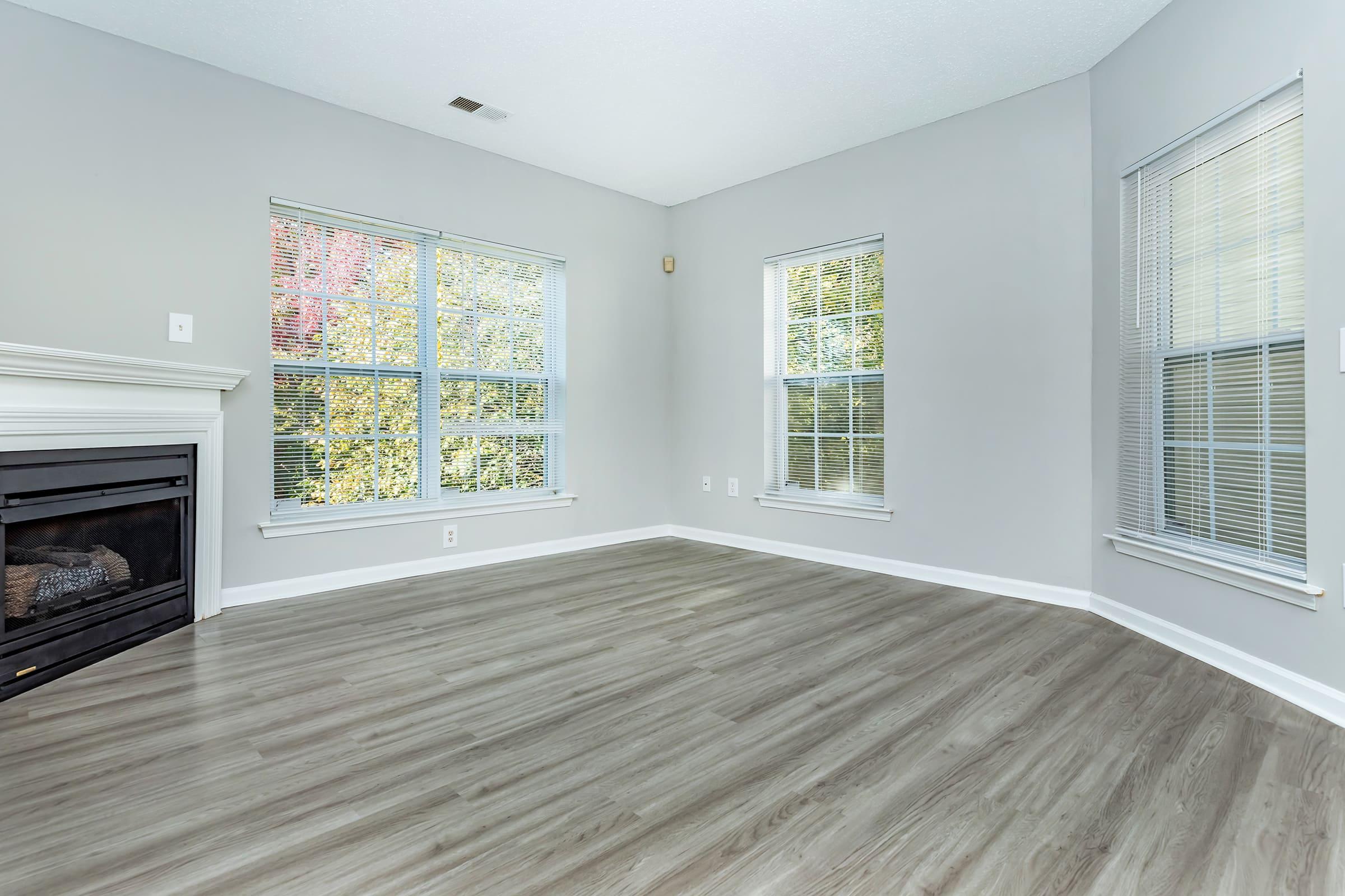 a living room with a fireplace and a large window