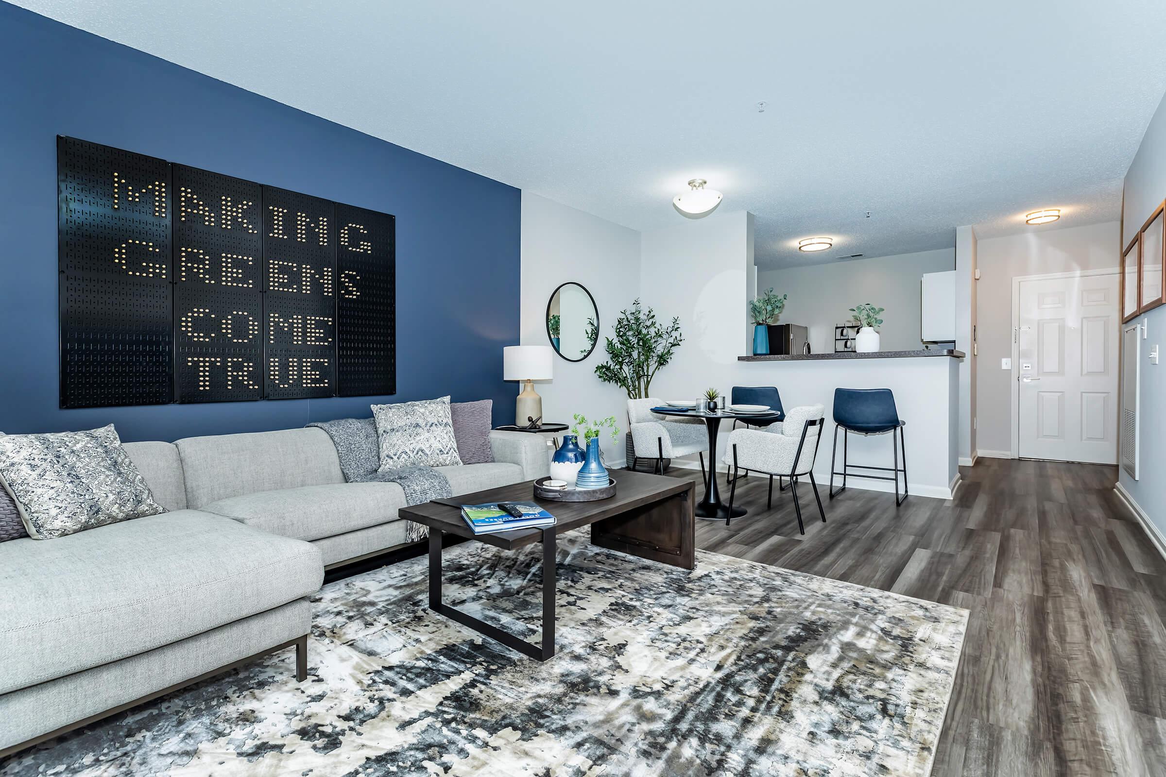 a living room filled with furniture and a large window