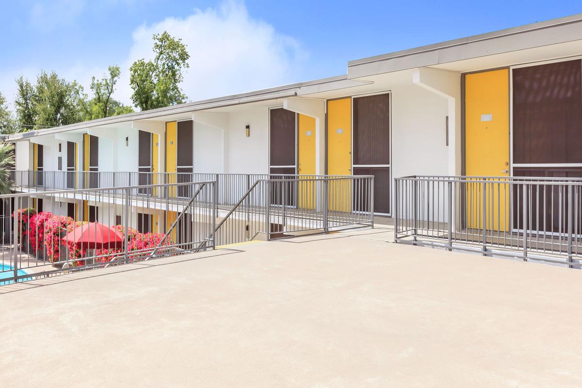 a house with a fence in front of a building