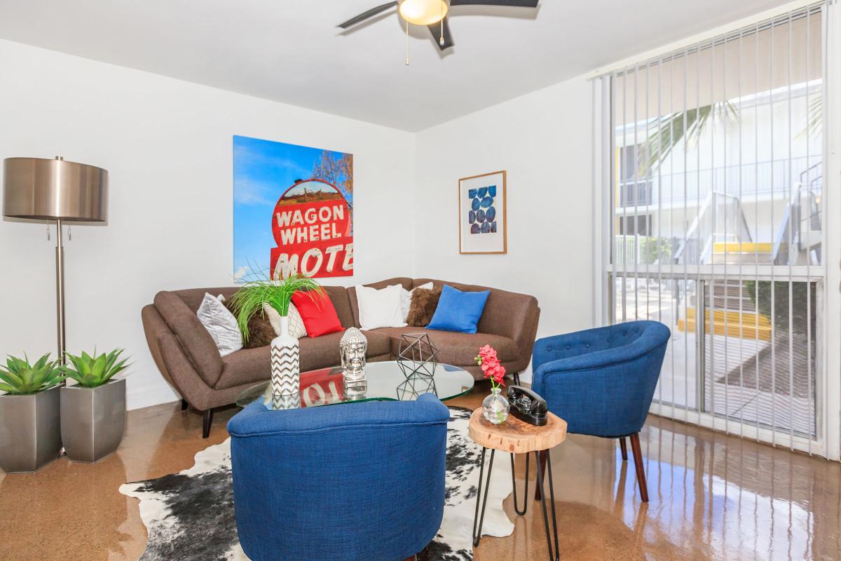 a living room filled with furniture and a blue chair