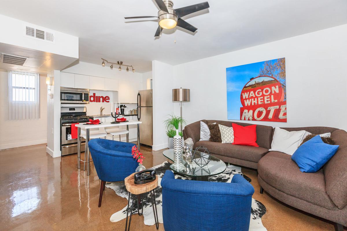 a living room filled with furniture and a blue sky