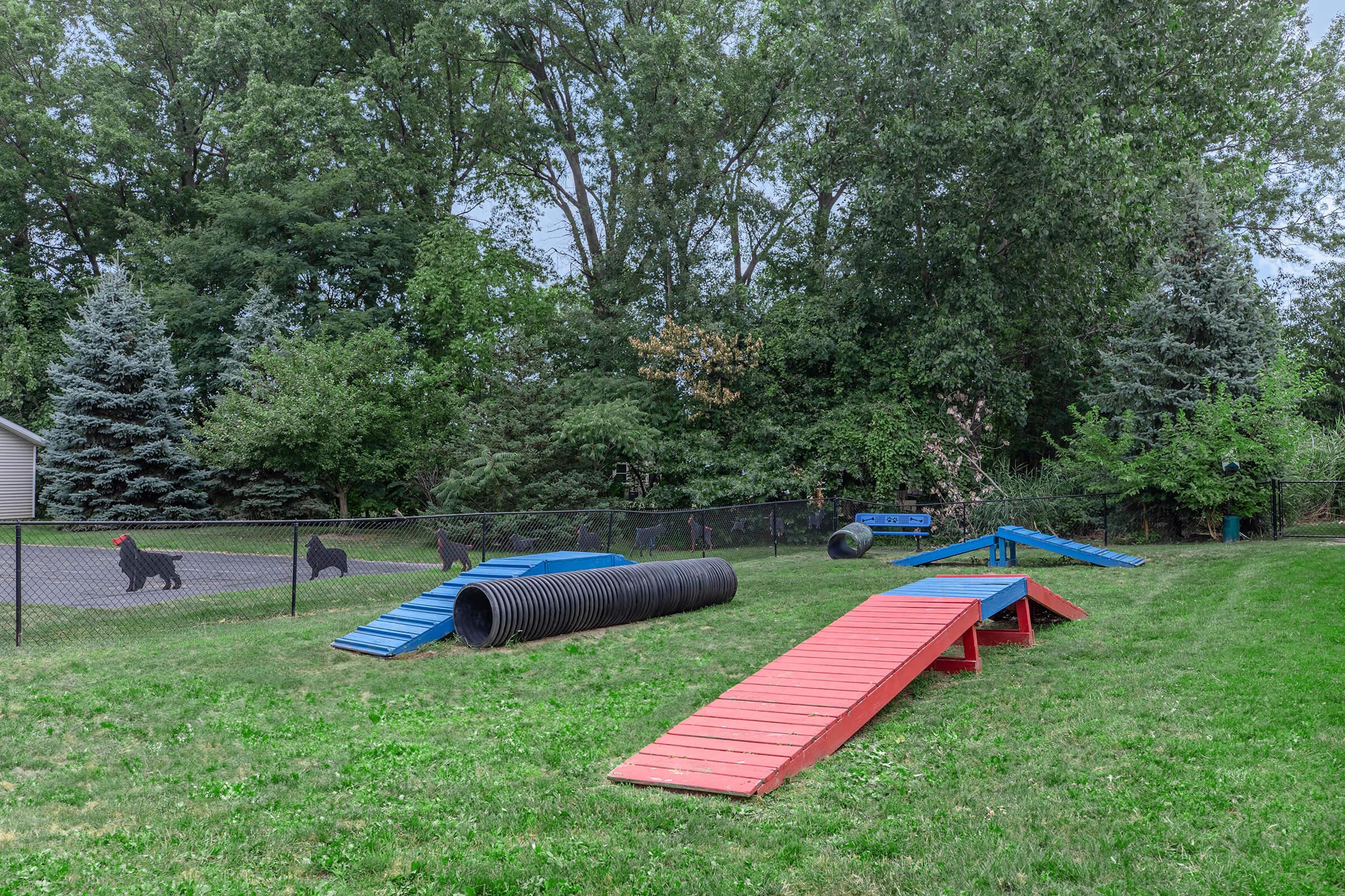 a group of lawn chairs sitting on top of a grass covered field