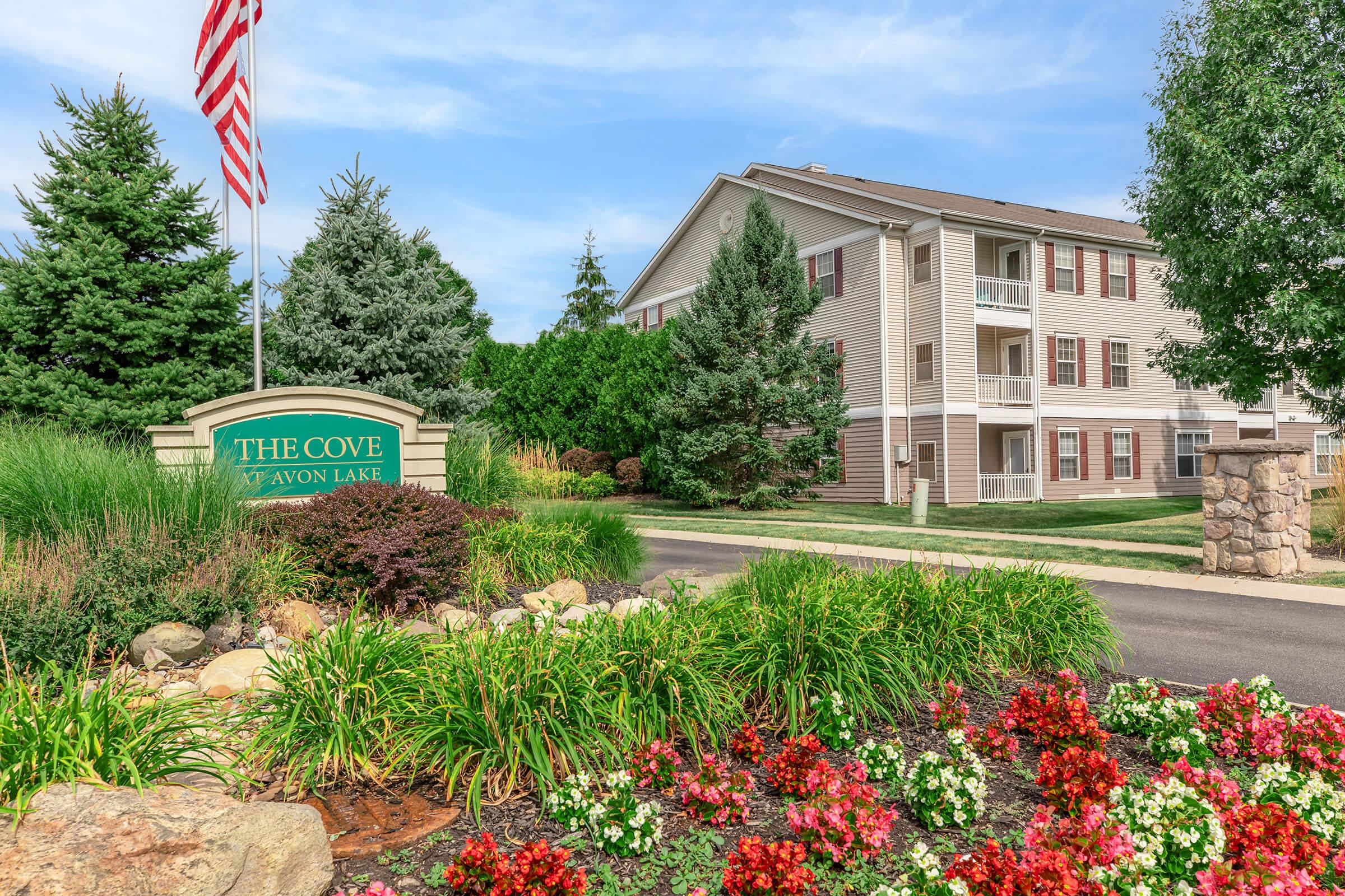 a close up of a flower garden in front of a building