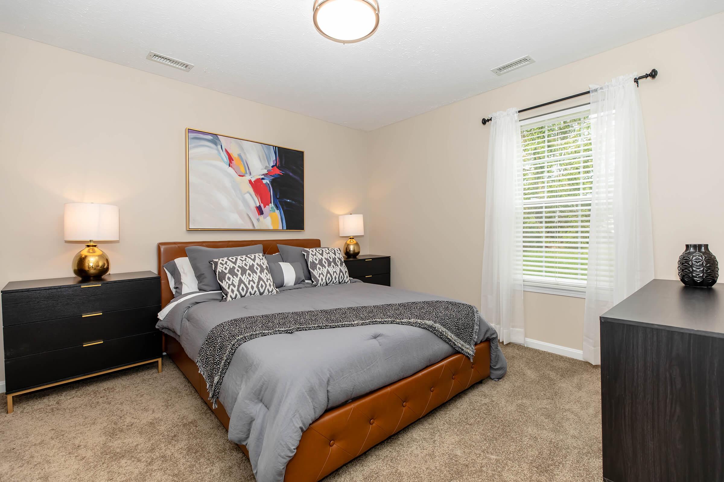 a bedroom with a bed and desk in a room