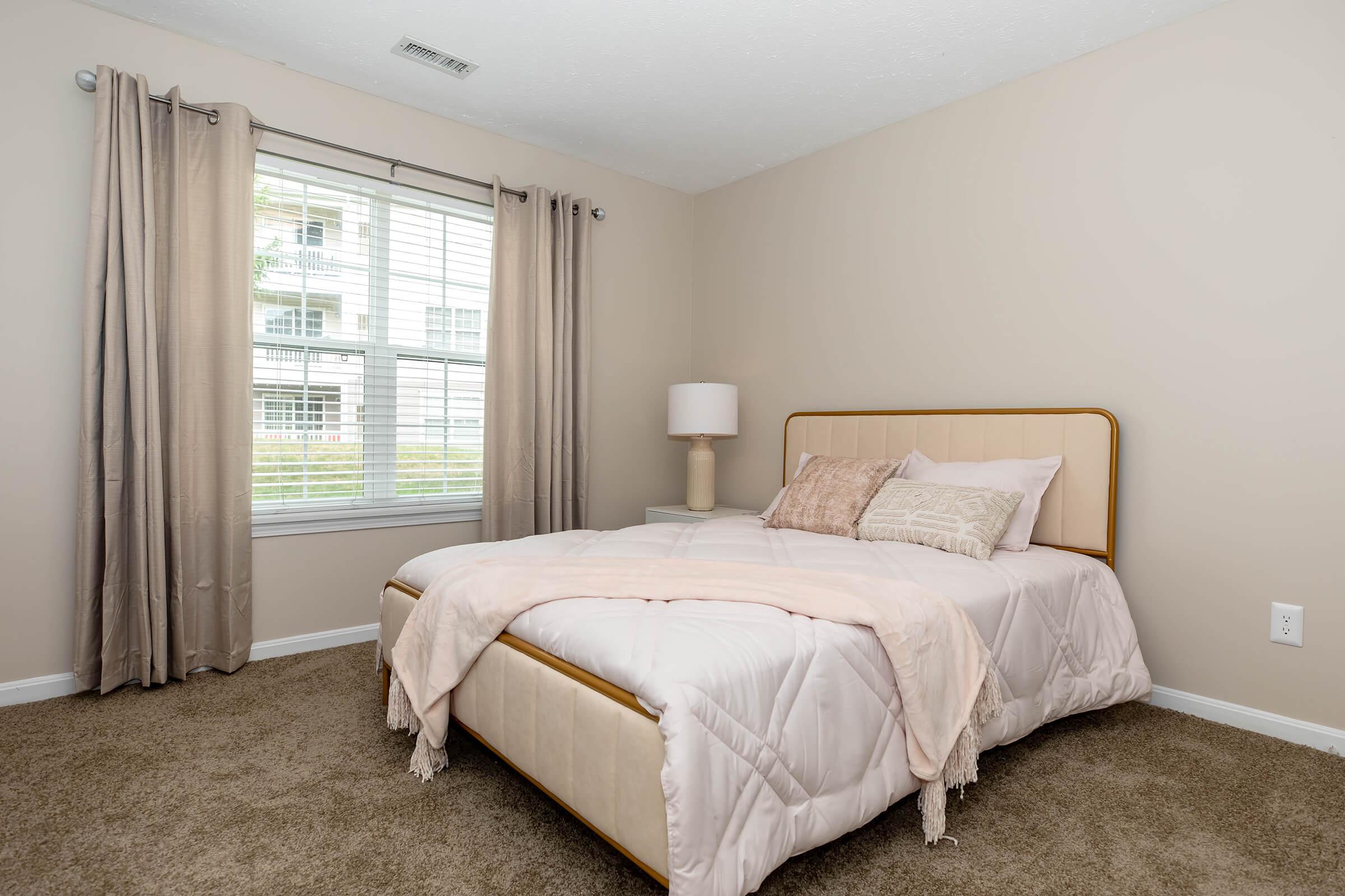 a bedroom with a large bed in a hotel room