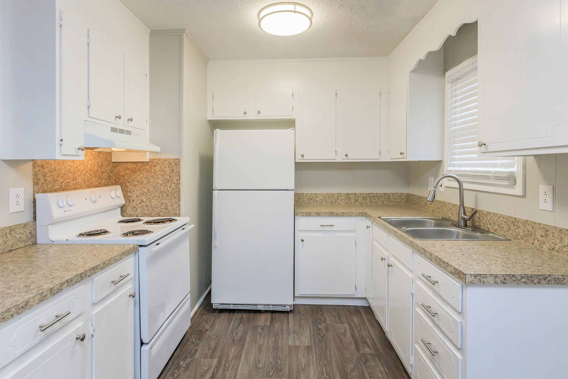 a kitchen with a stove sink and refrigerator