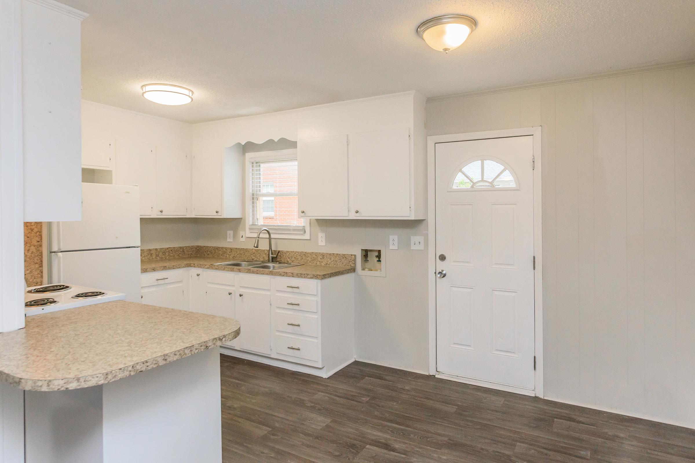 a kitchen with a sink and a refrigerator