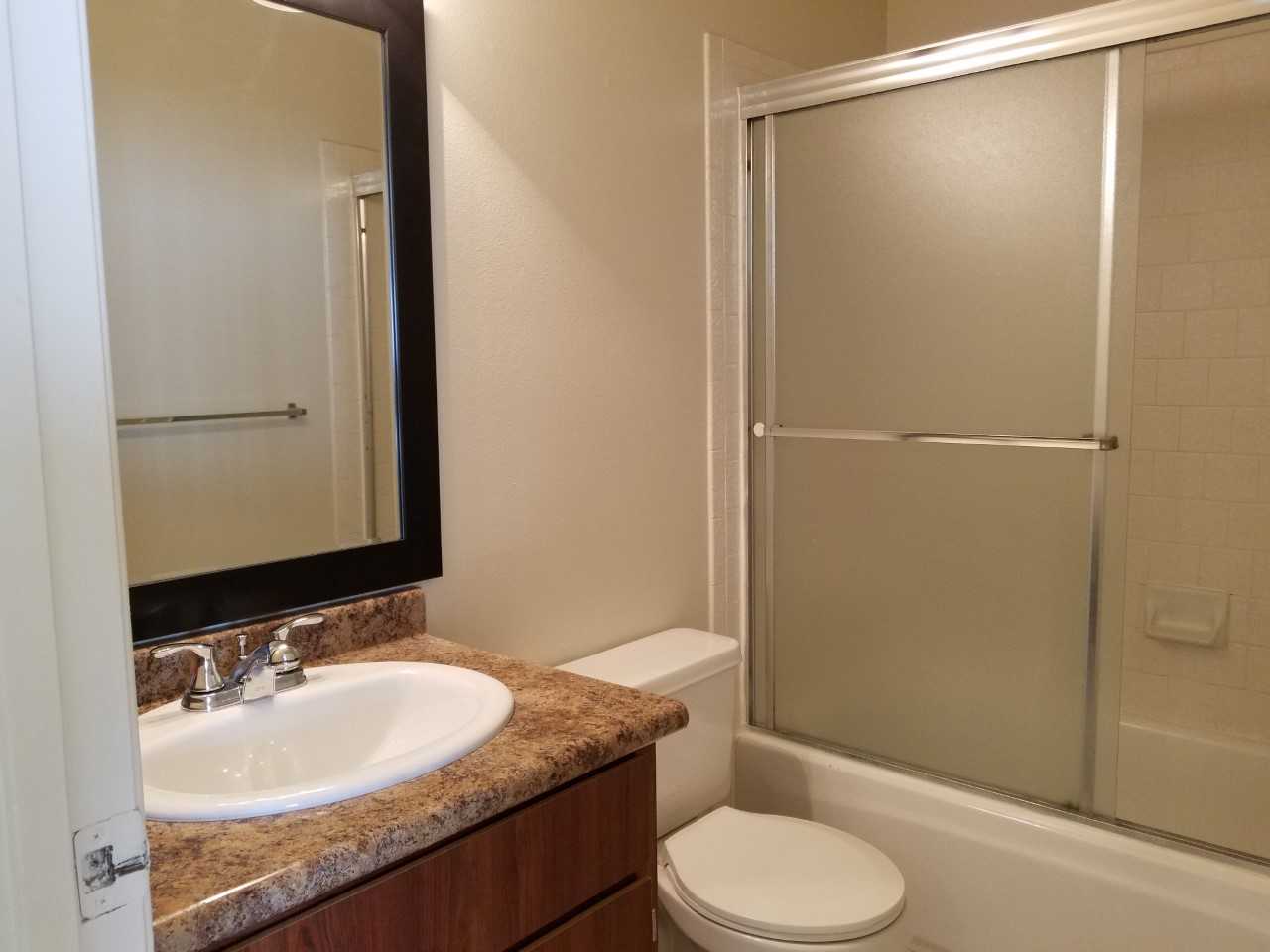 a shower that has a sink and a mirror