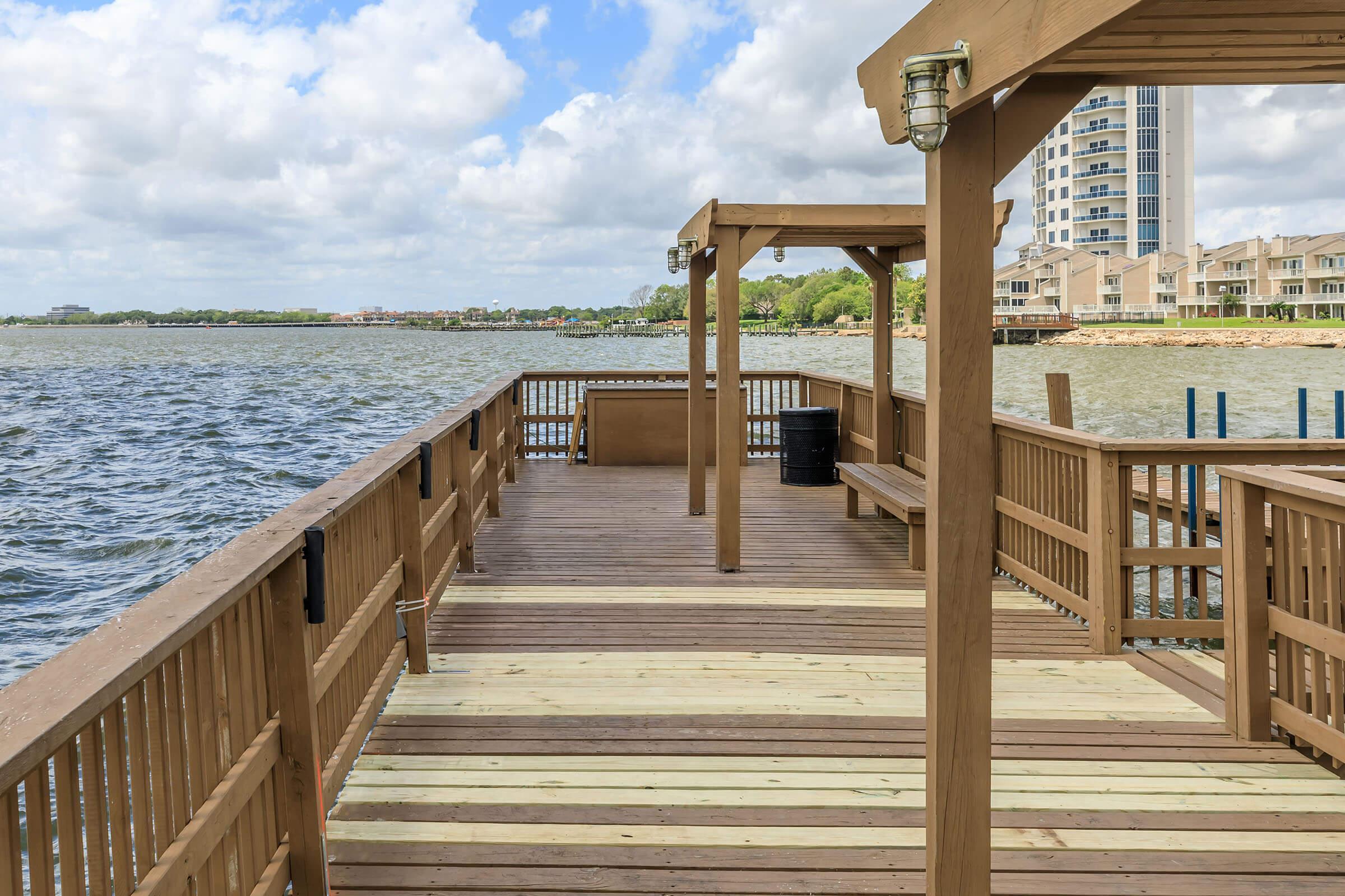 a wooden pier next to a body of water