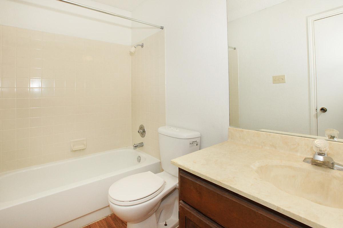 a white tub sitting next to a sink