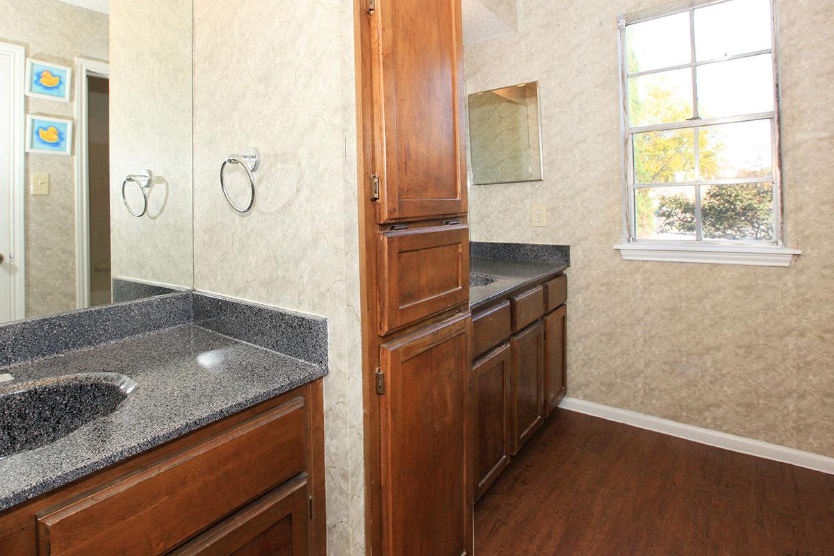 a kitchen with wooden cabinets and a sink