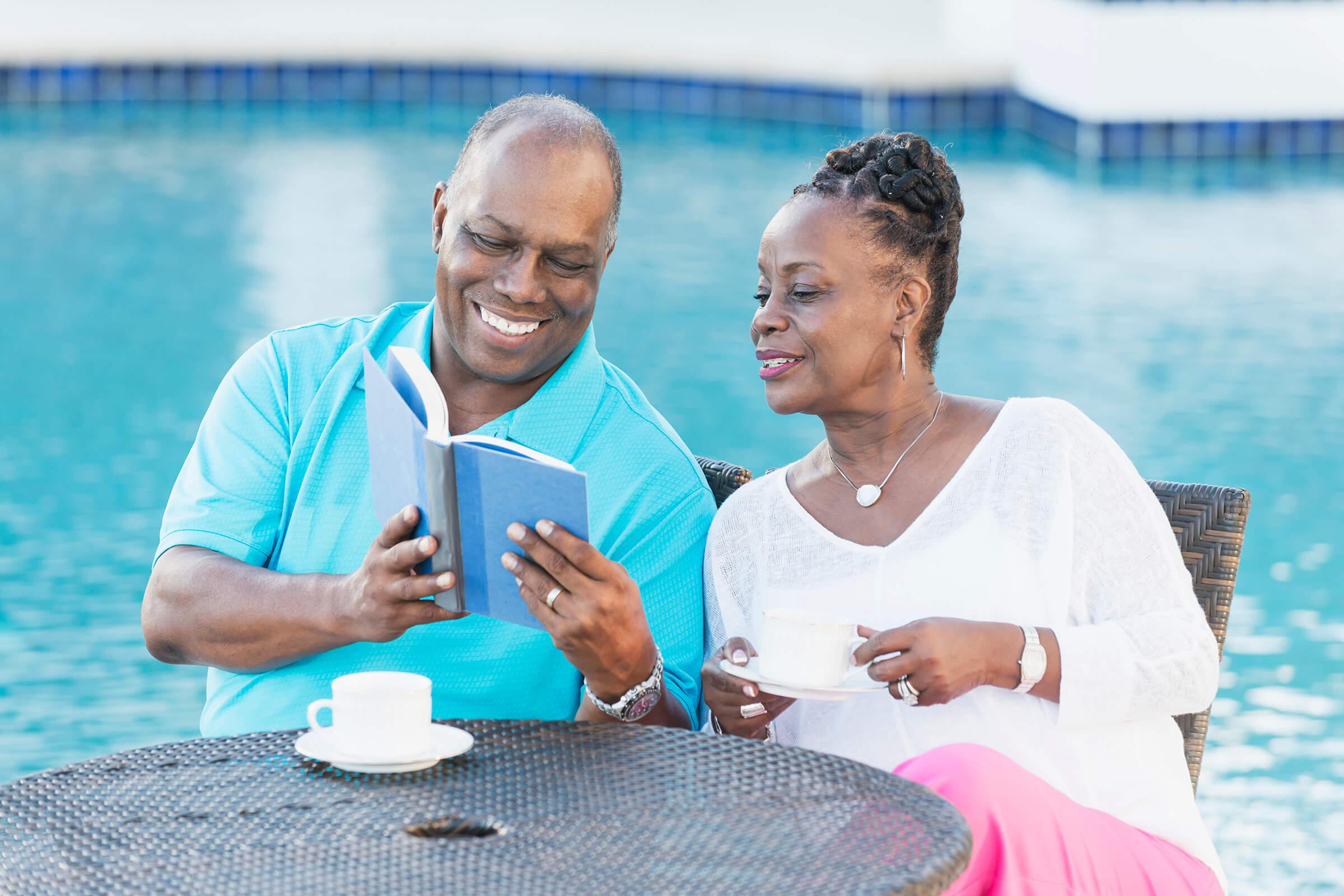 Man and Woman Reading by the Pool