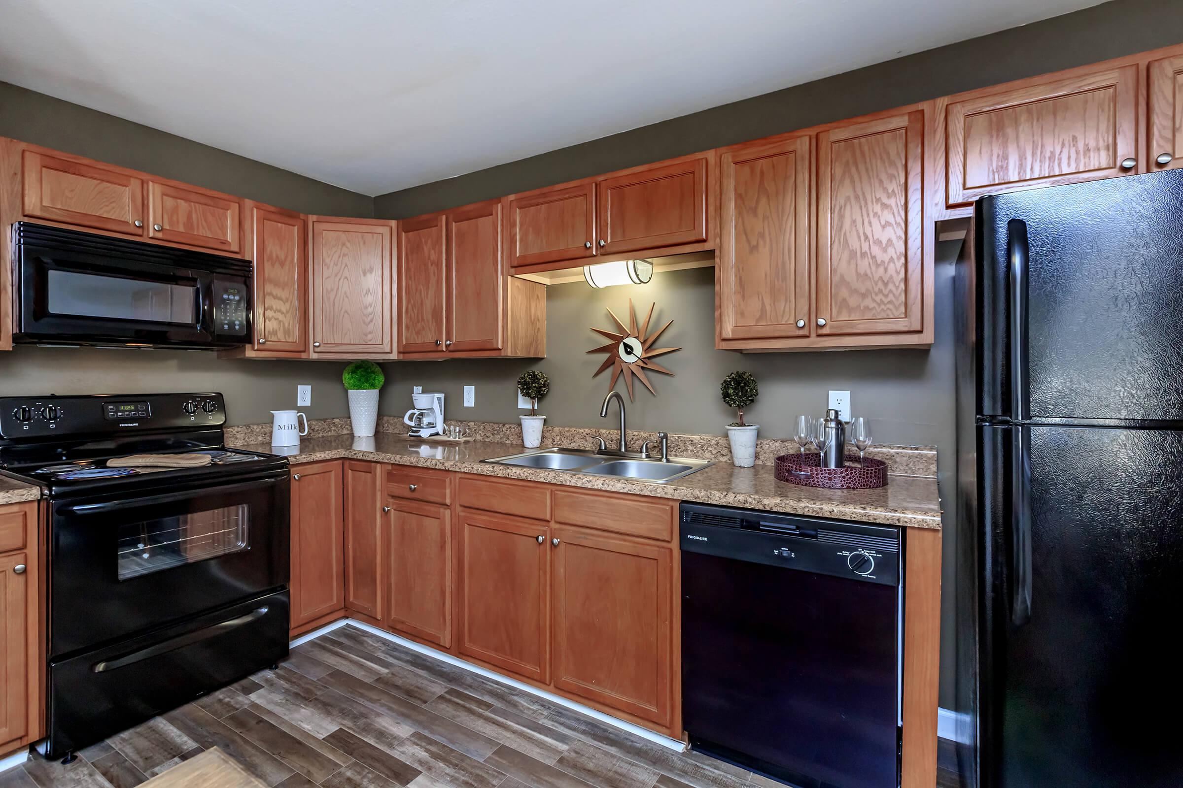 a modern kitchen with stainless steel appliances and wooden cabinets