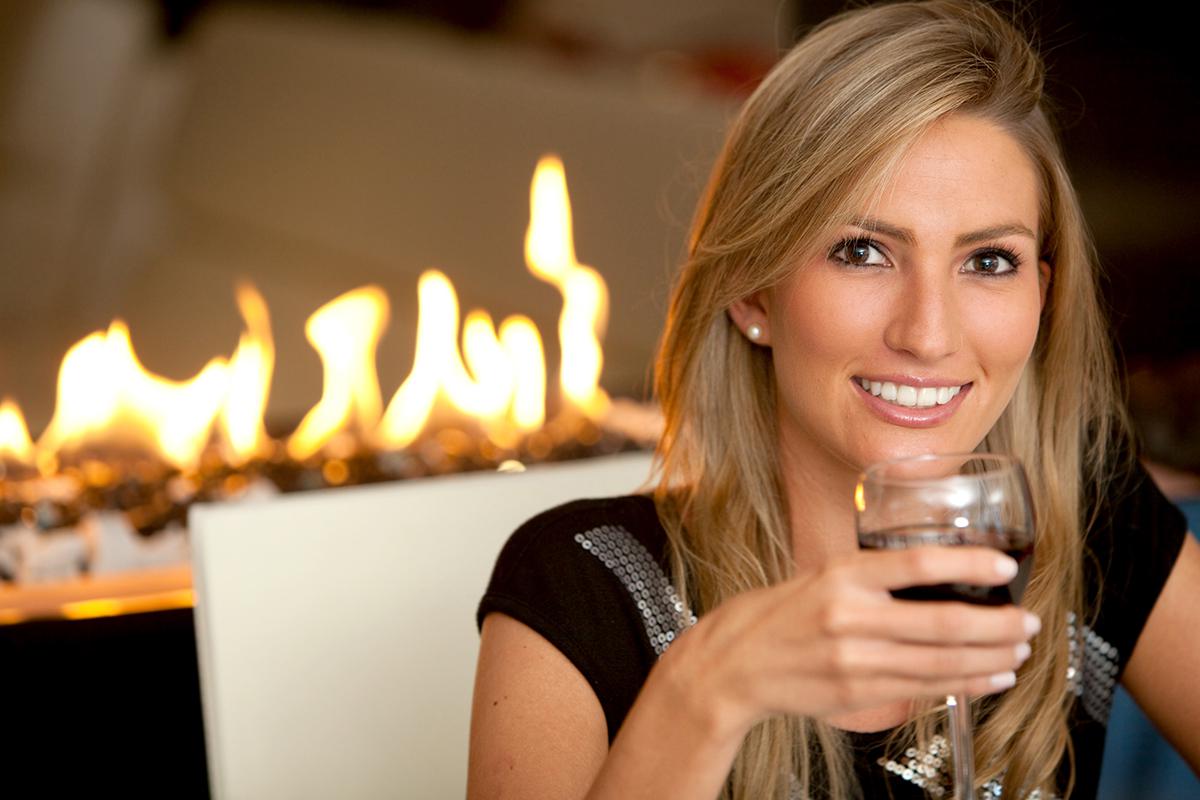 a woman holding a wine glass posing for the camera