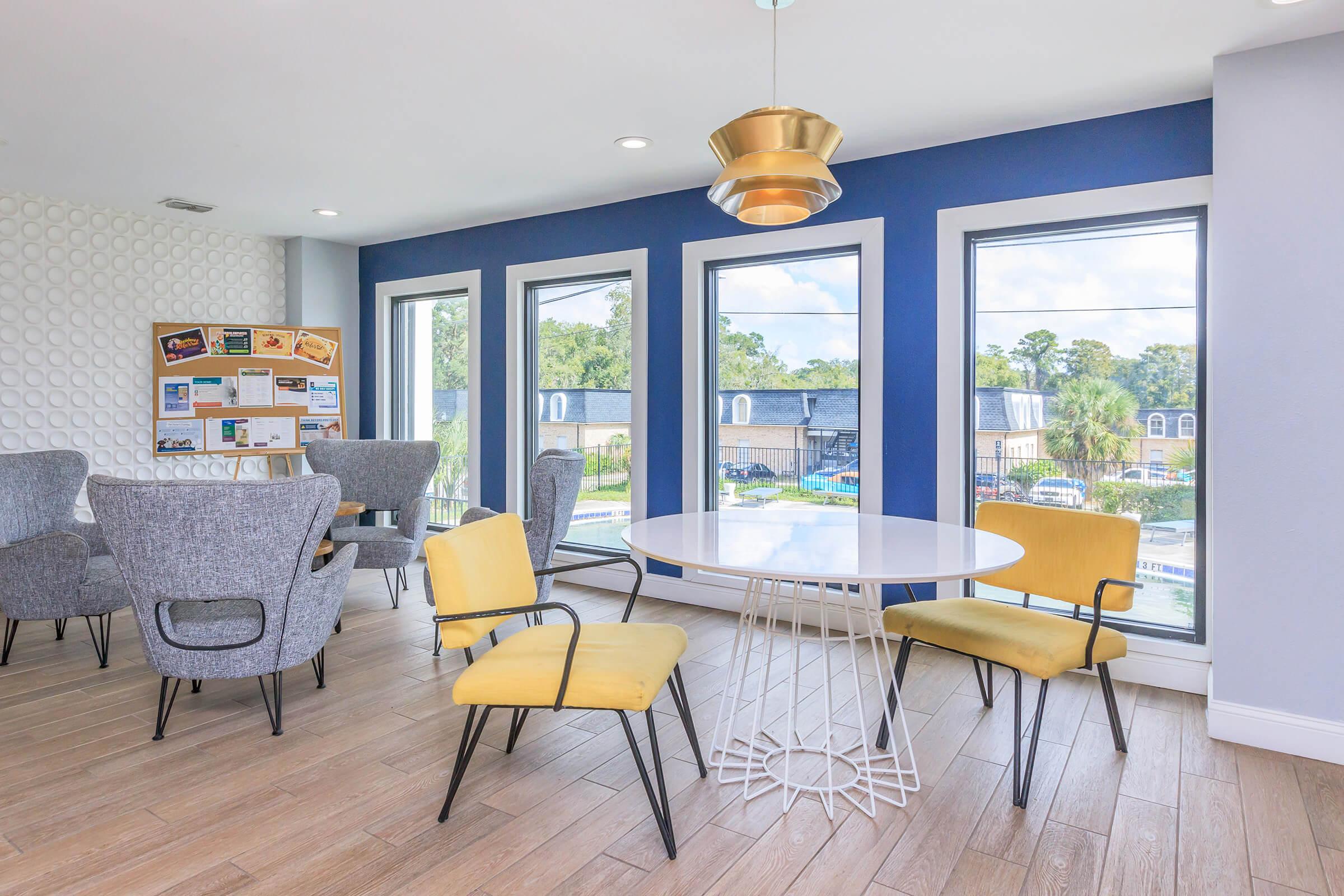 a living room filled with furniture and a large window