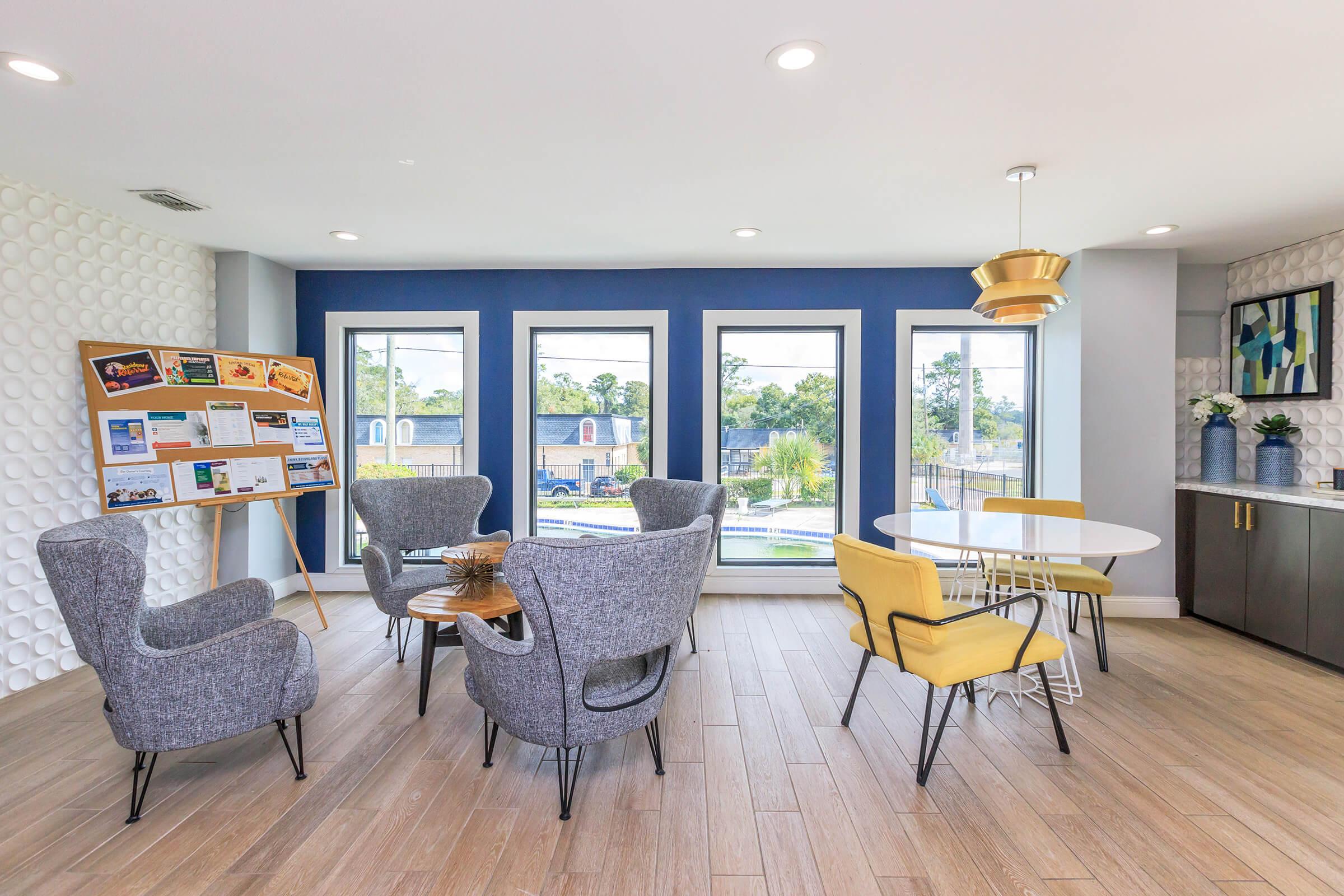 a living room filled with furniture on top of a wooden floor