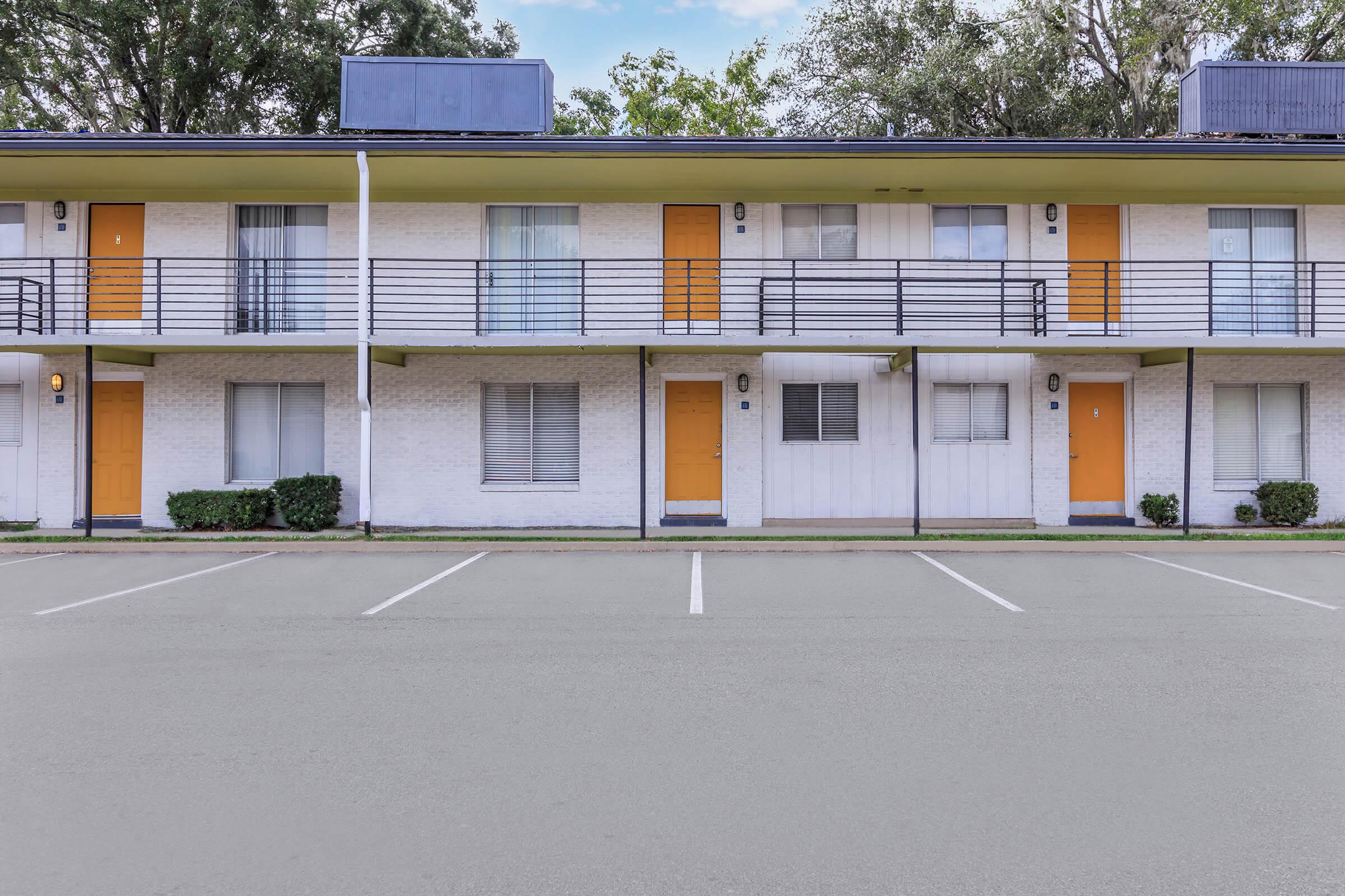 a large empty parking lot in front of a building