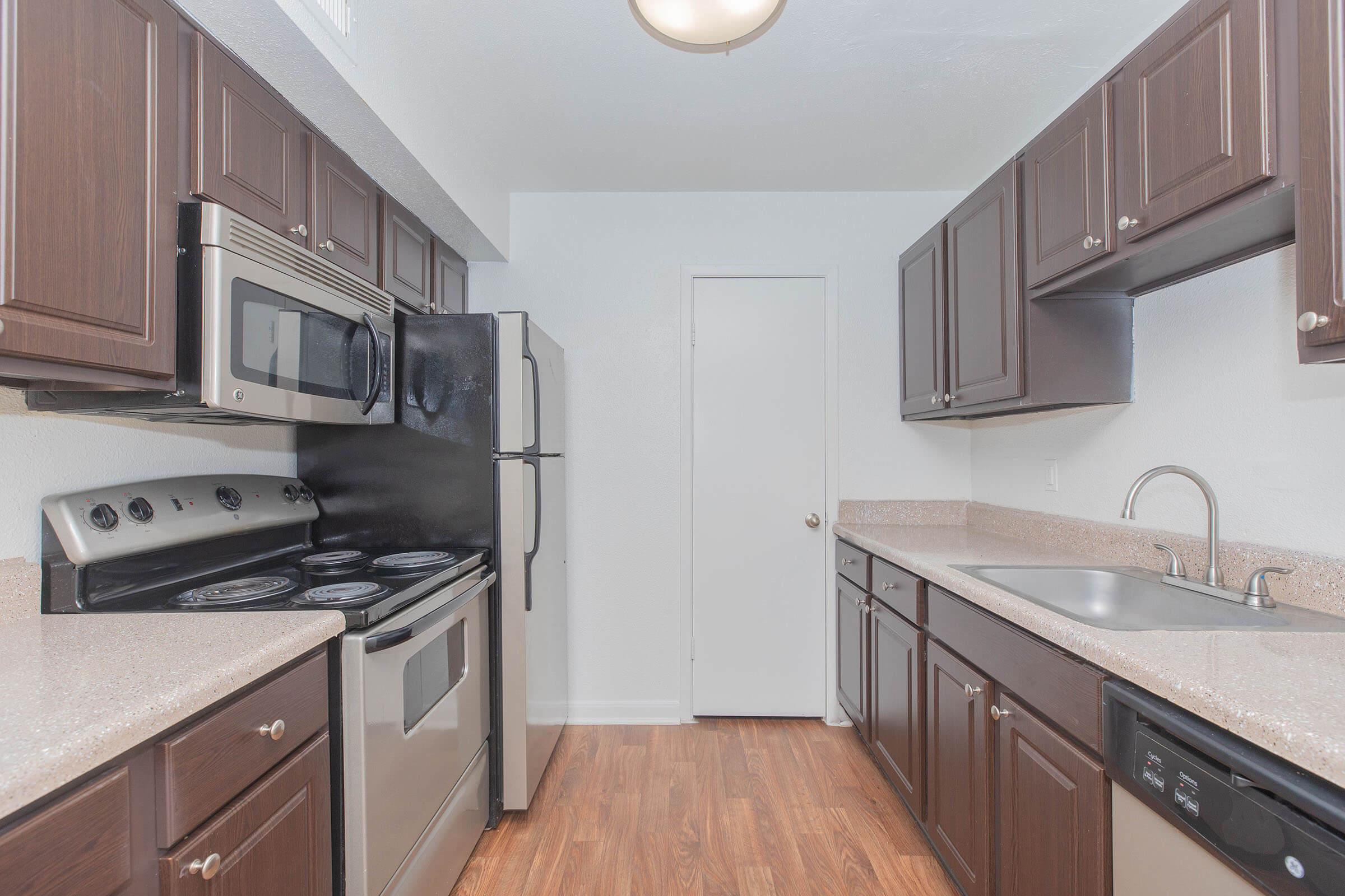 a kitchen with stainless steel appliances and wooden cabinets