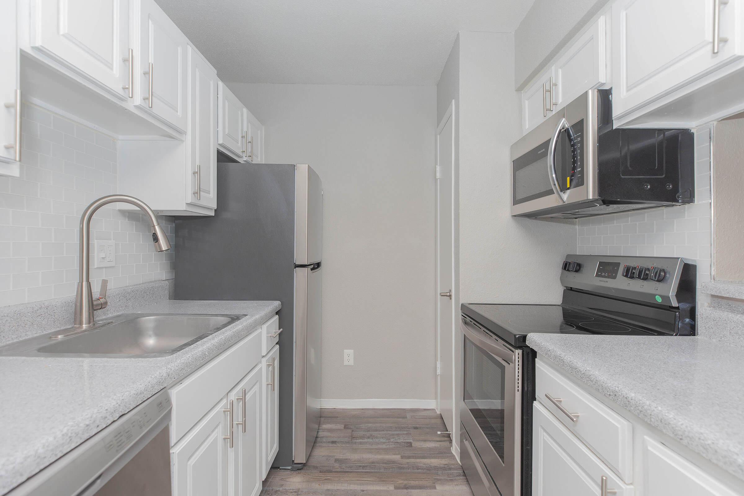 a kitchen with a sink and a microwave