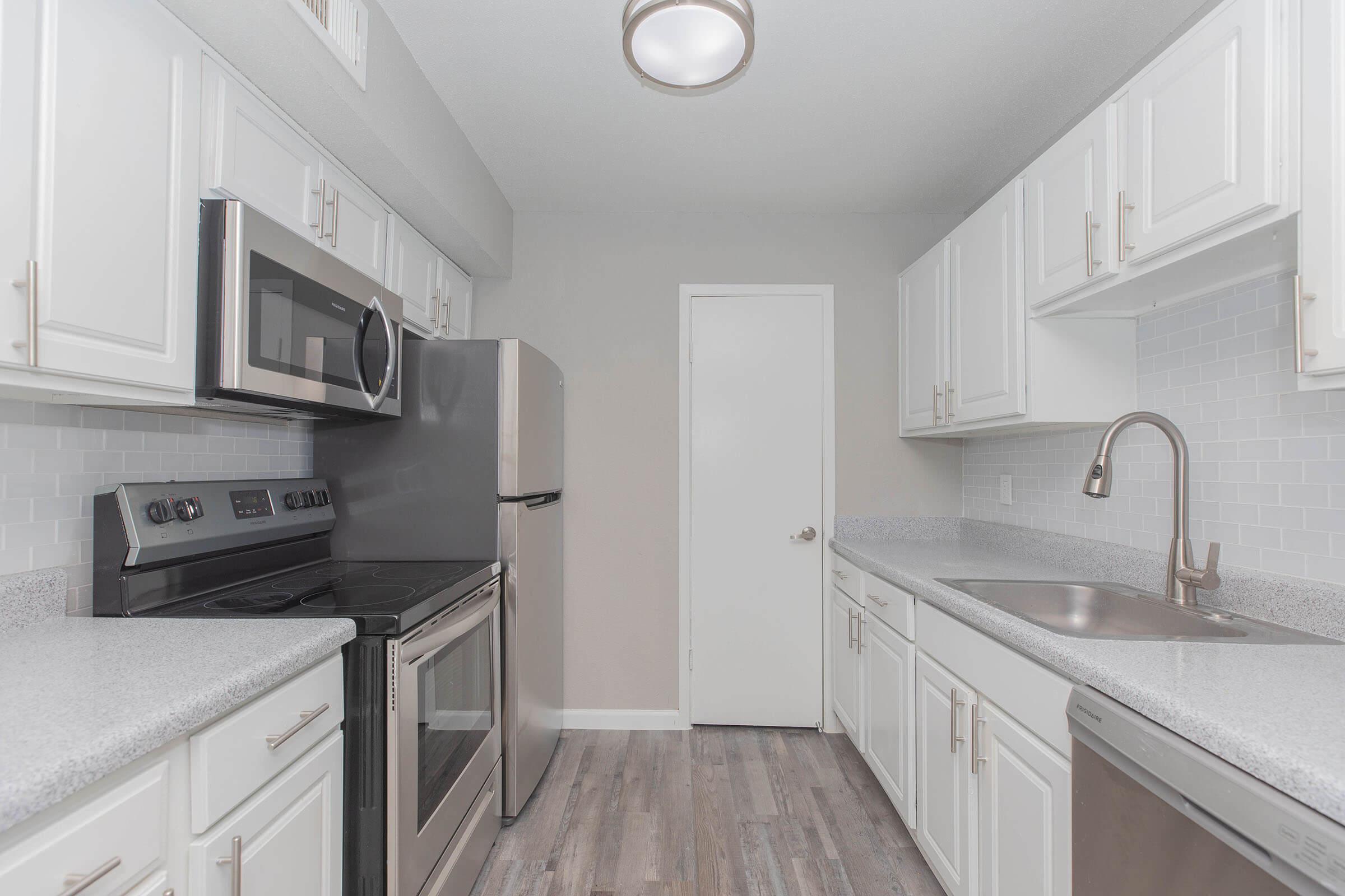 a kitchen with a sink and a microwave