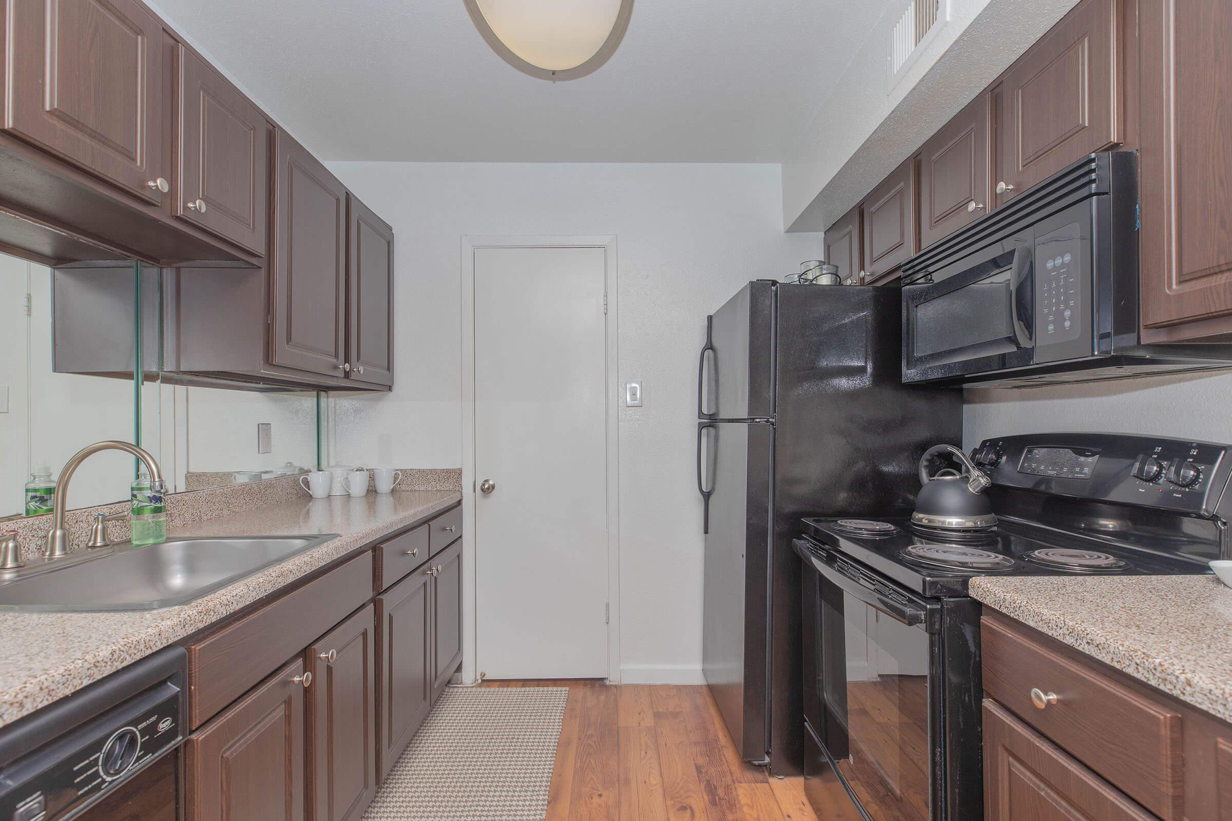 a kitchen with stainless steel appliances and wooden cabinets