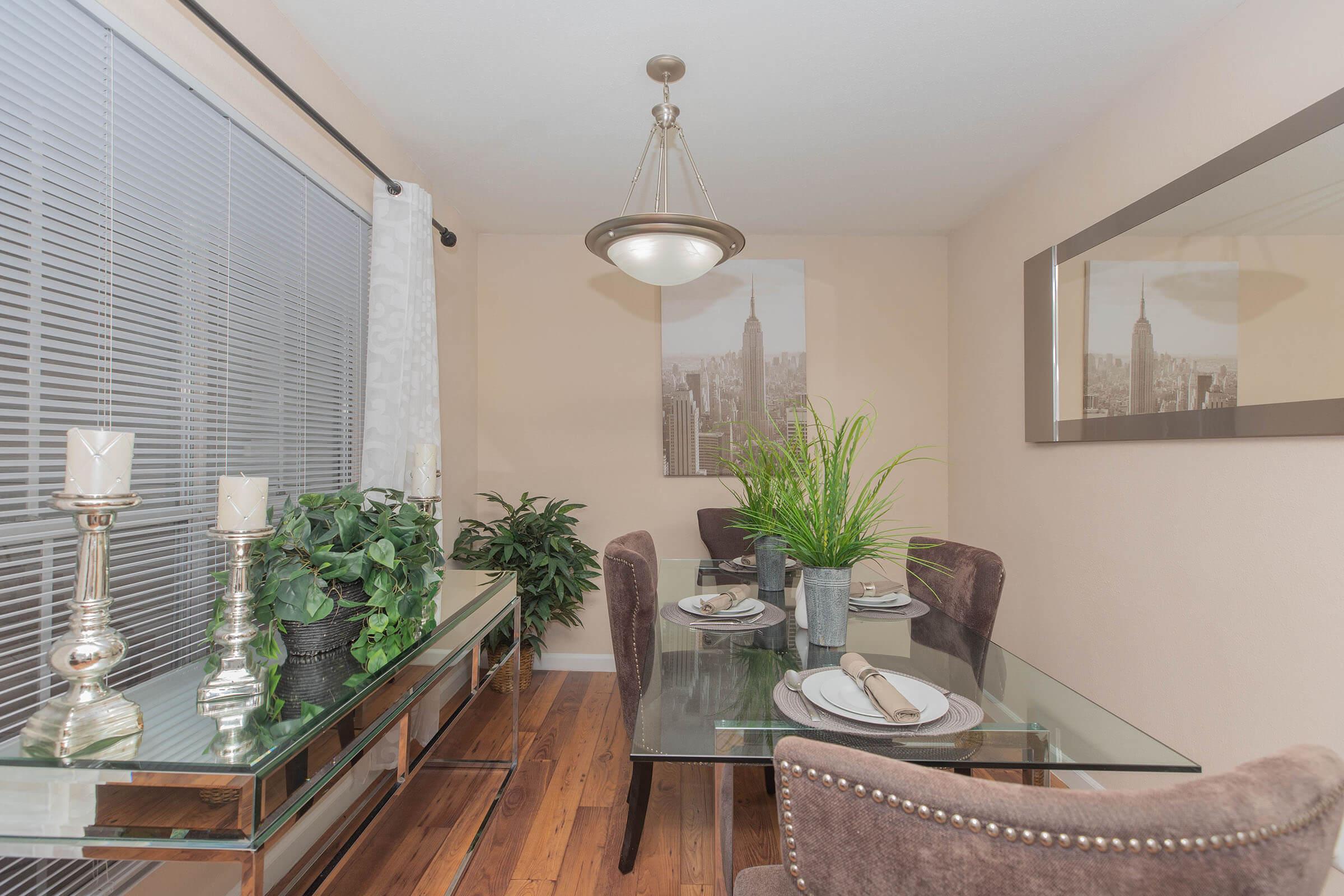 a living room filled with furniture and vase of flowers on a table