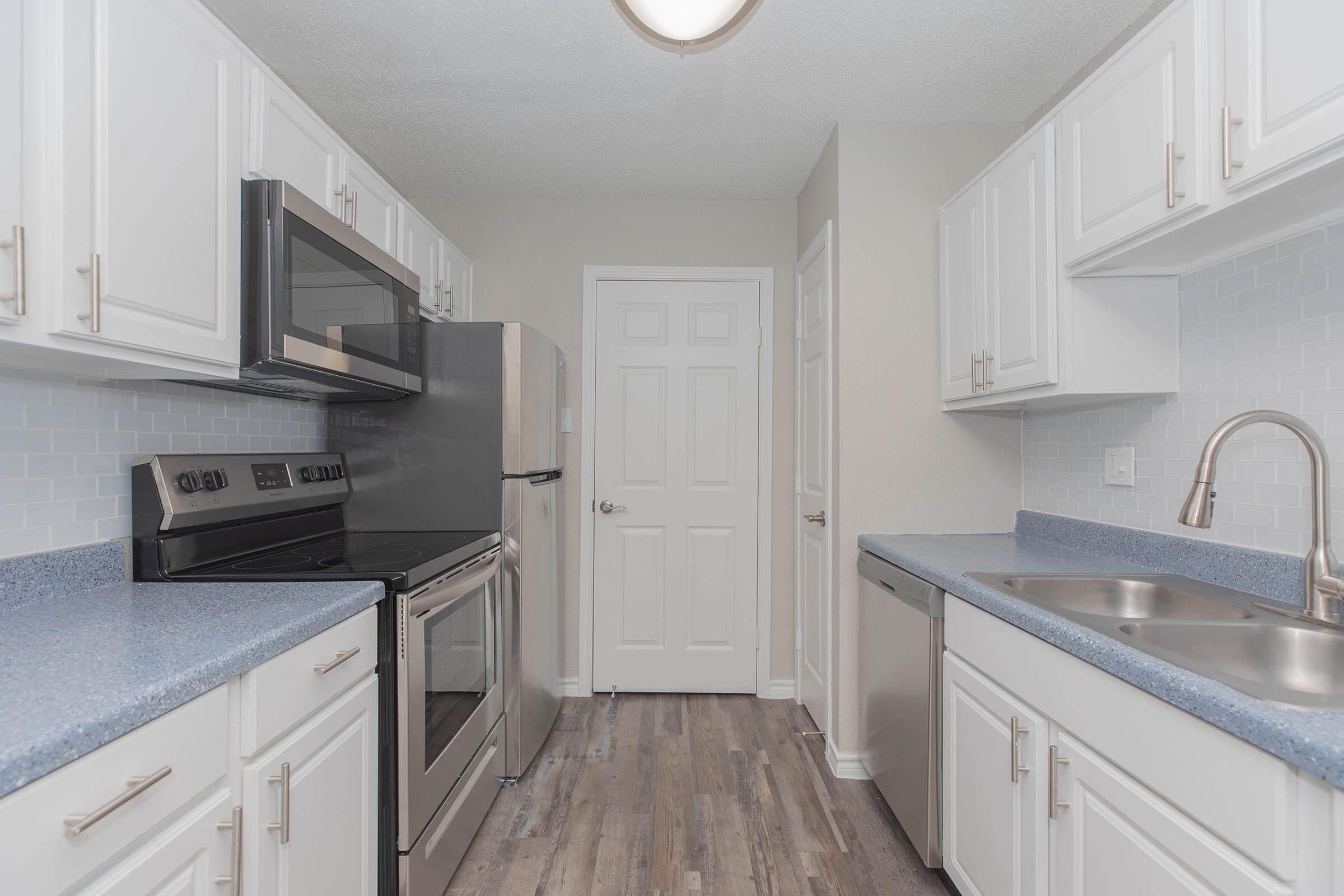 a kitchen with a stove and a sink