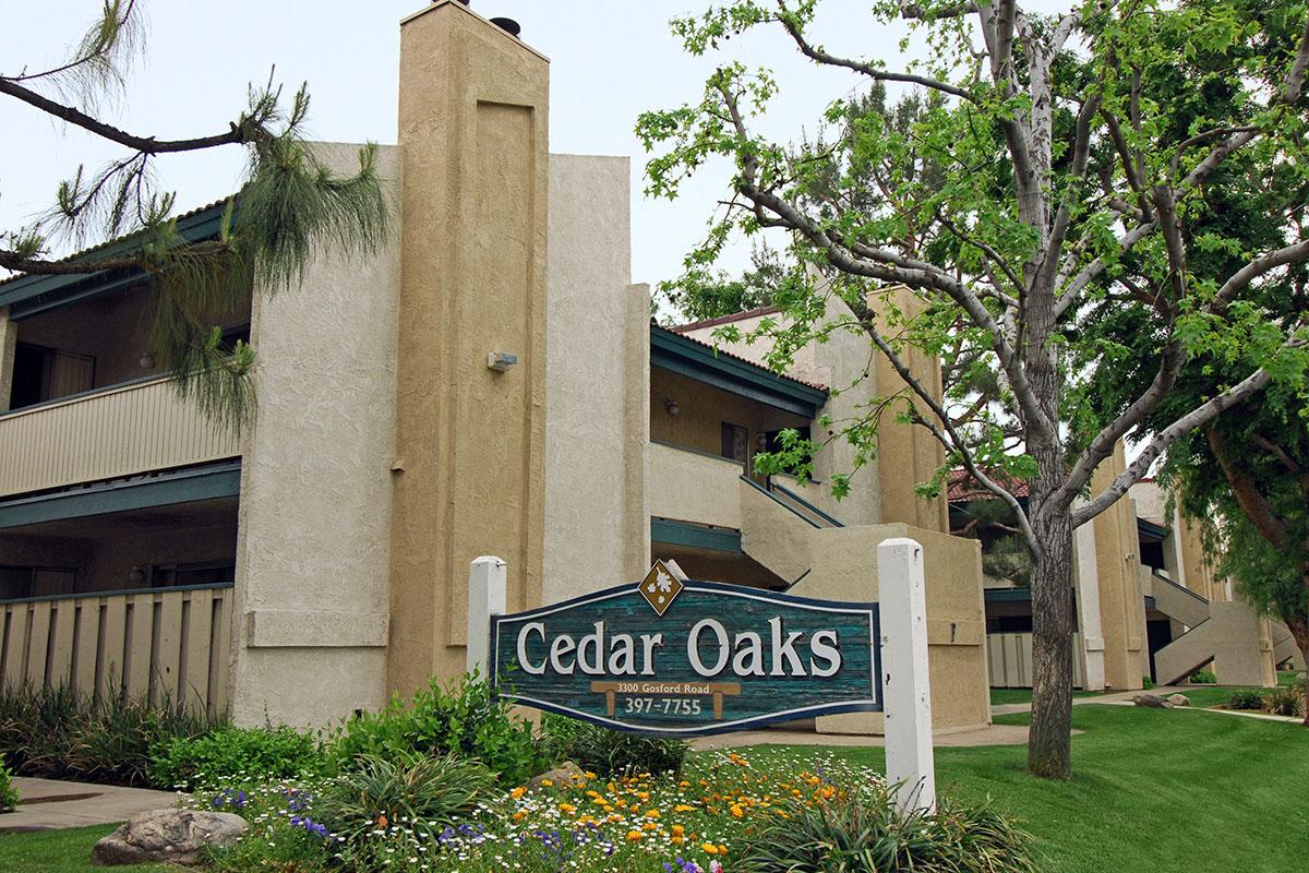 Cedar Oaks Apartments monument sign with a community building