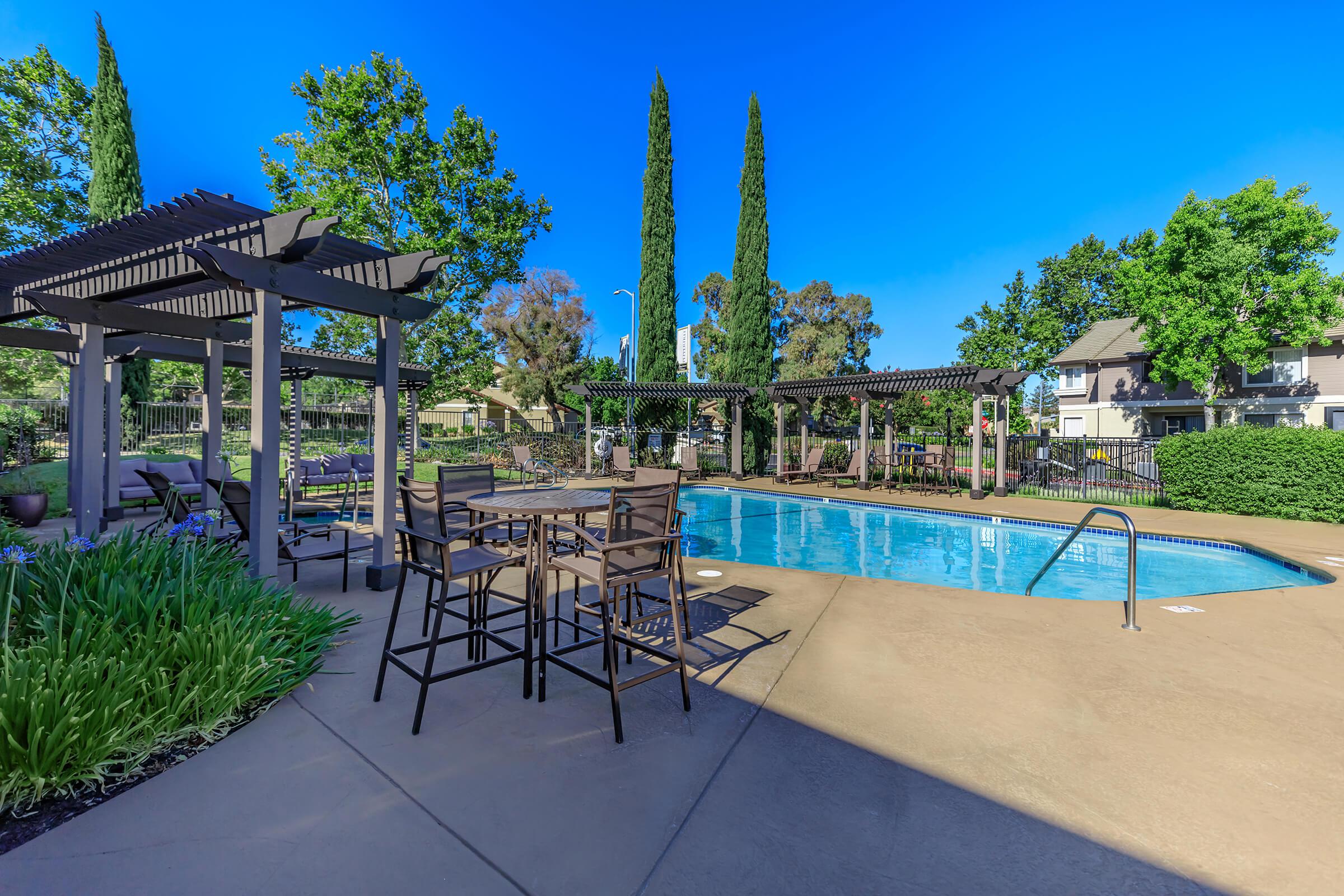 a group of lawn chairs sitting next to a pool