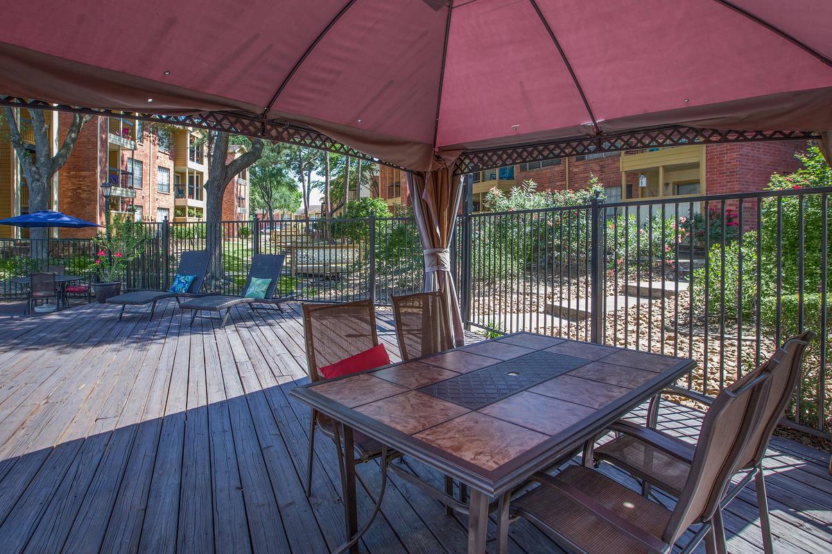 an umbrella sitting on top of a wooden table