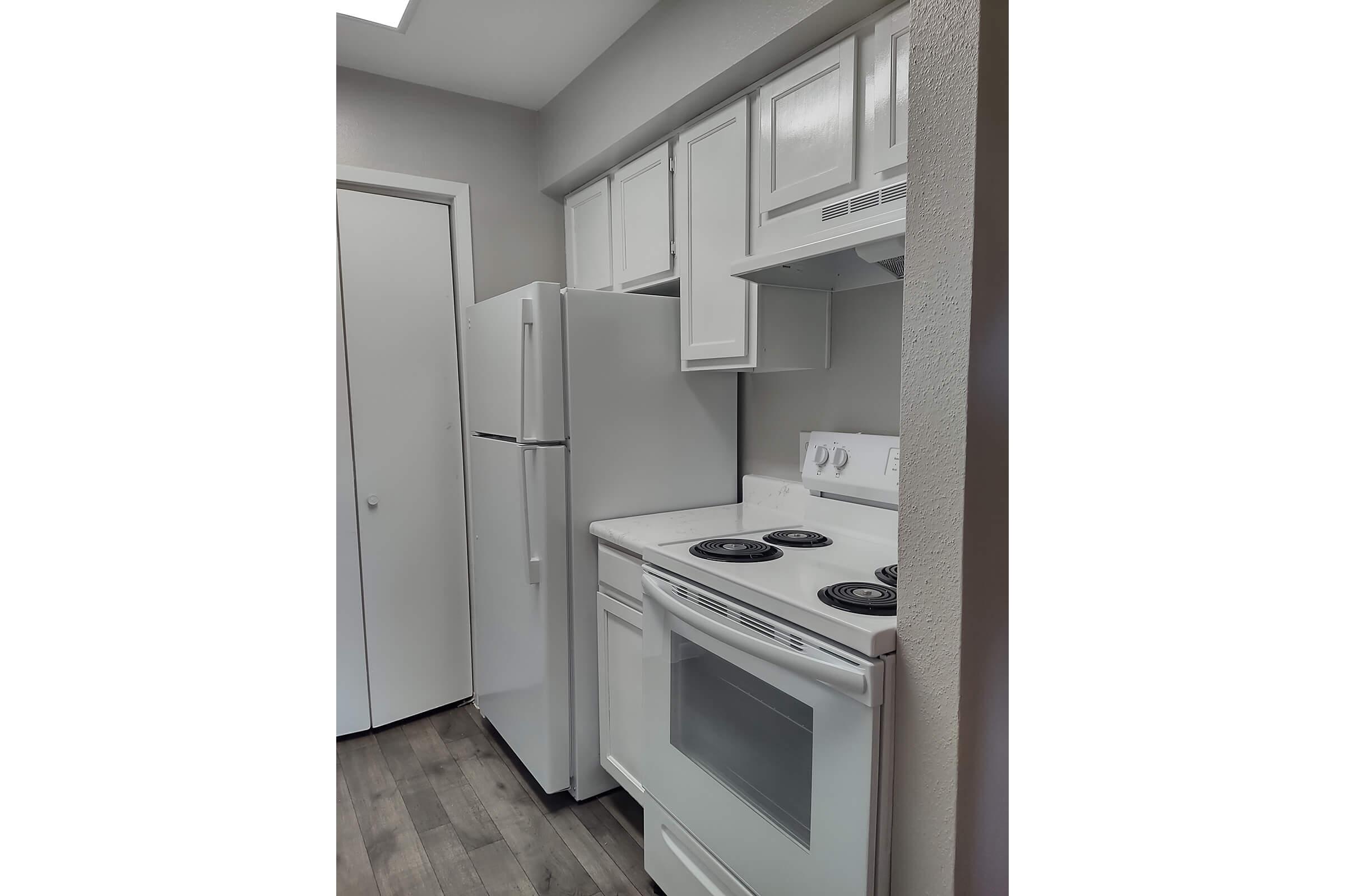 a kitchen with a stove top oven sitting inside of a refrigerator