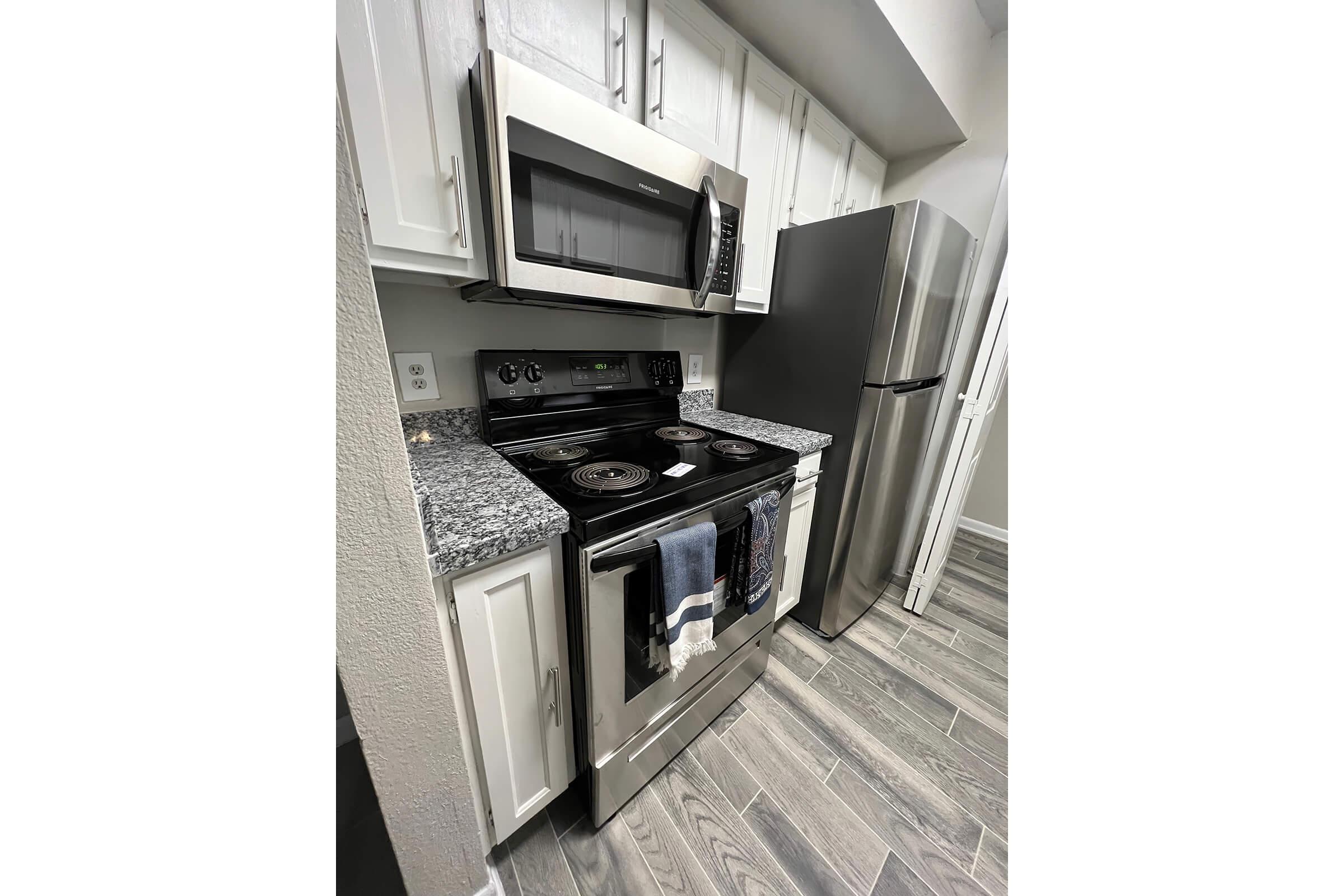 a stove top oven sitting inside of a kitchen