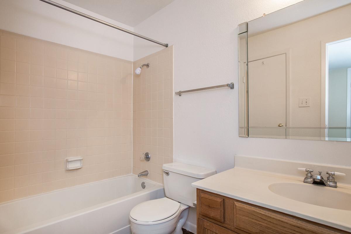 a large white tub sitting next to a sink