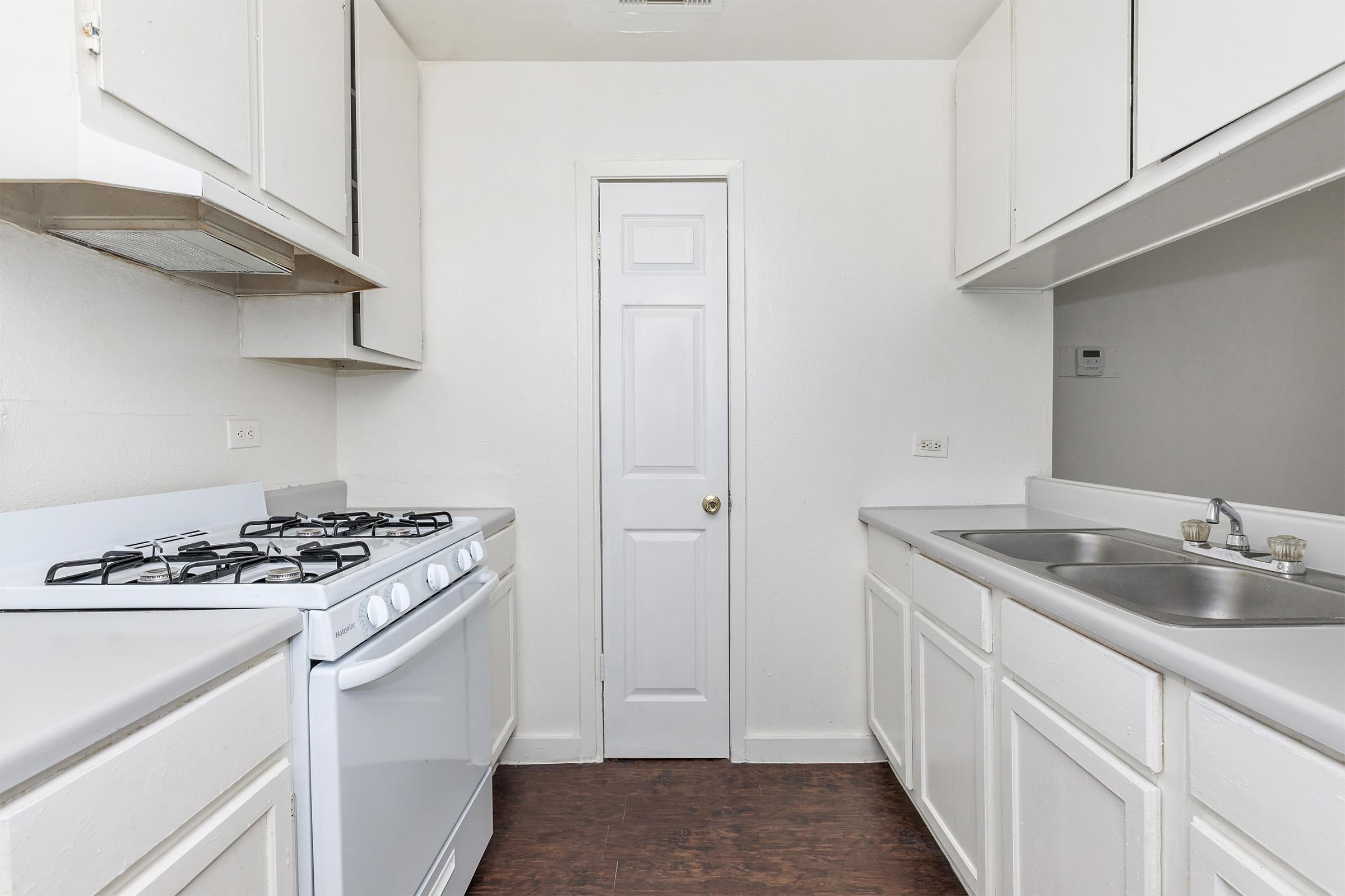 a kitchen with a stove and a sink
