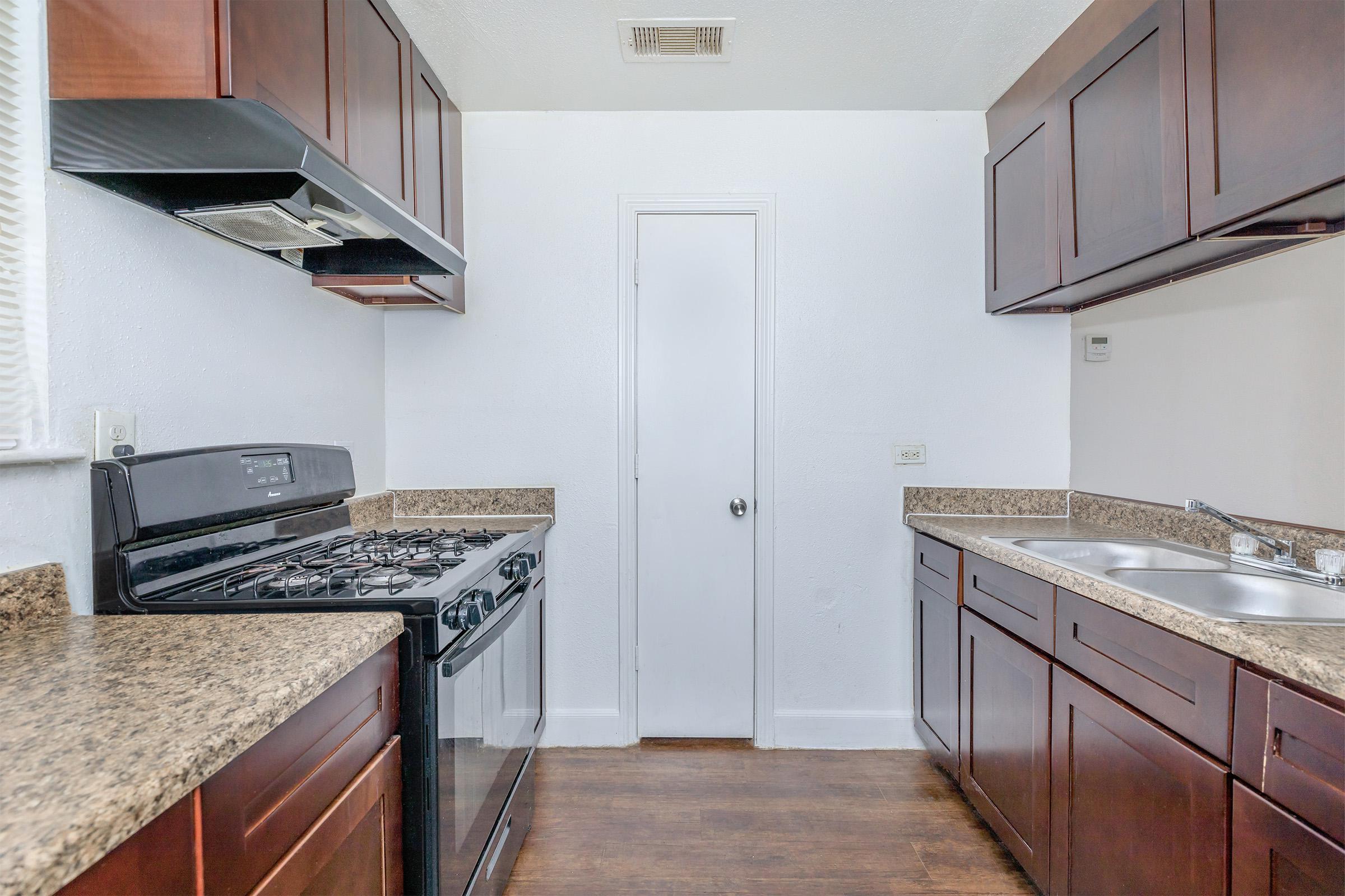 a kitchen with a stove top oven