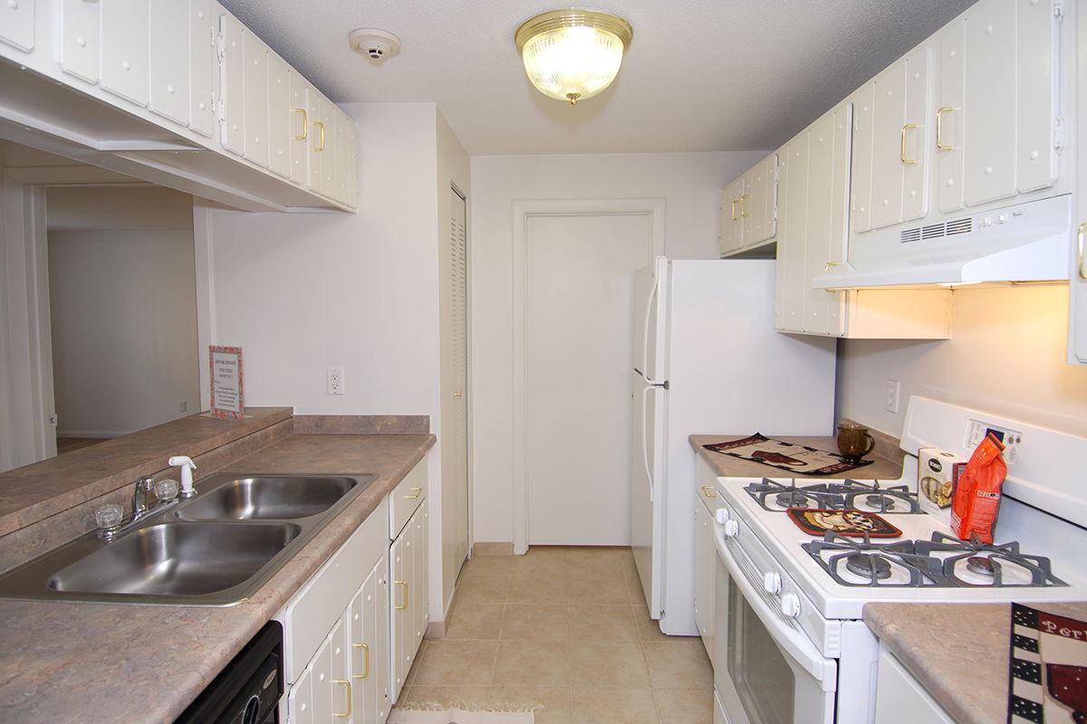 a kitchen with a stove sink and refrigerator