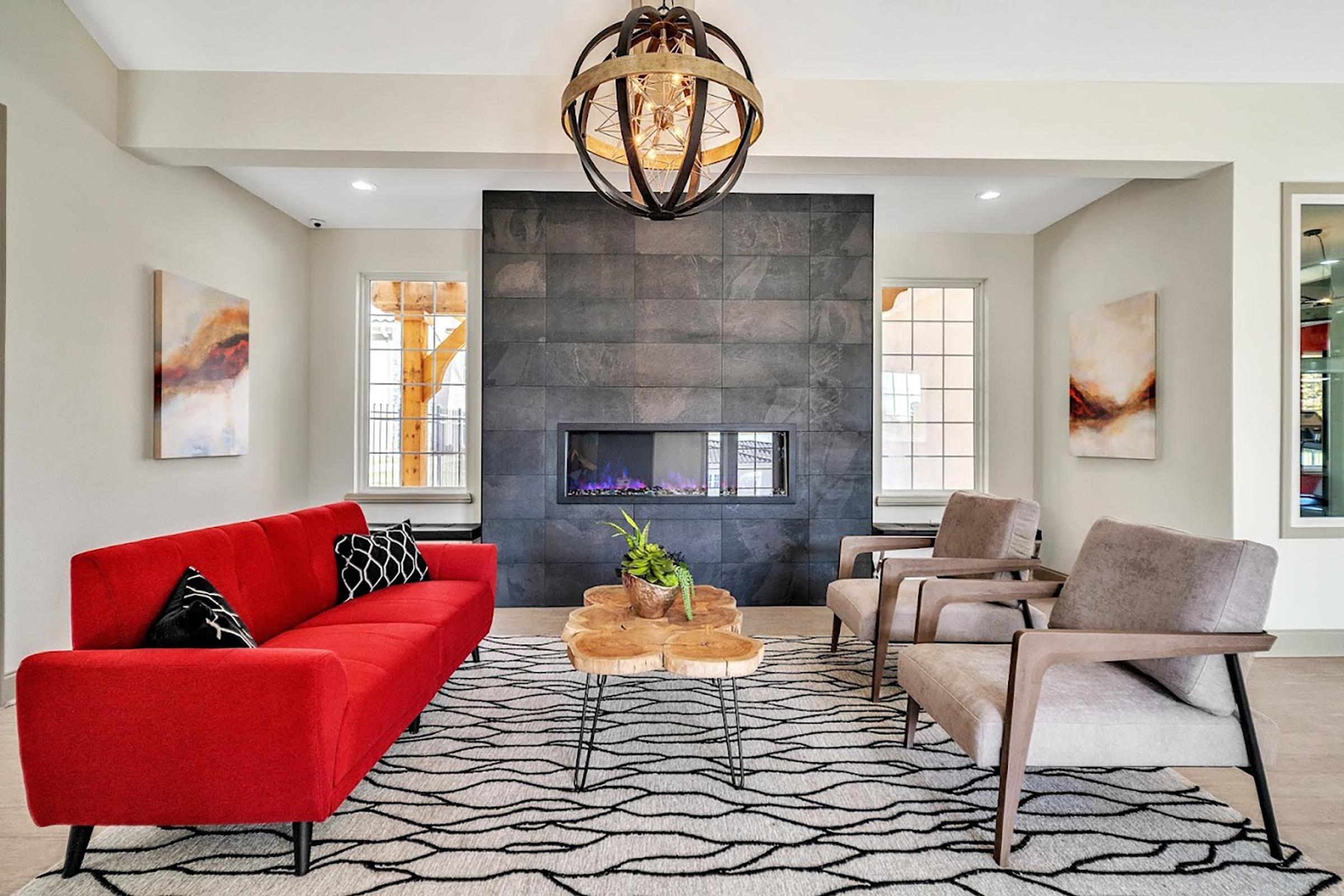 a living room filled with furniture and a fire place sitting in a chair