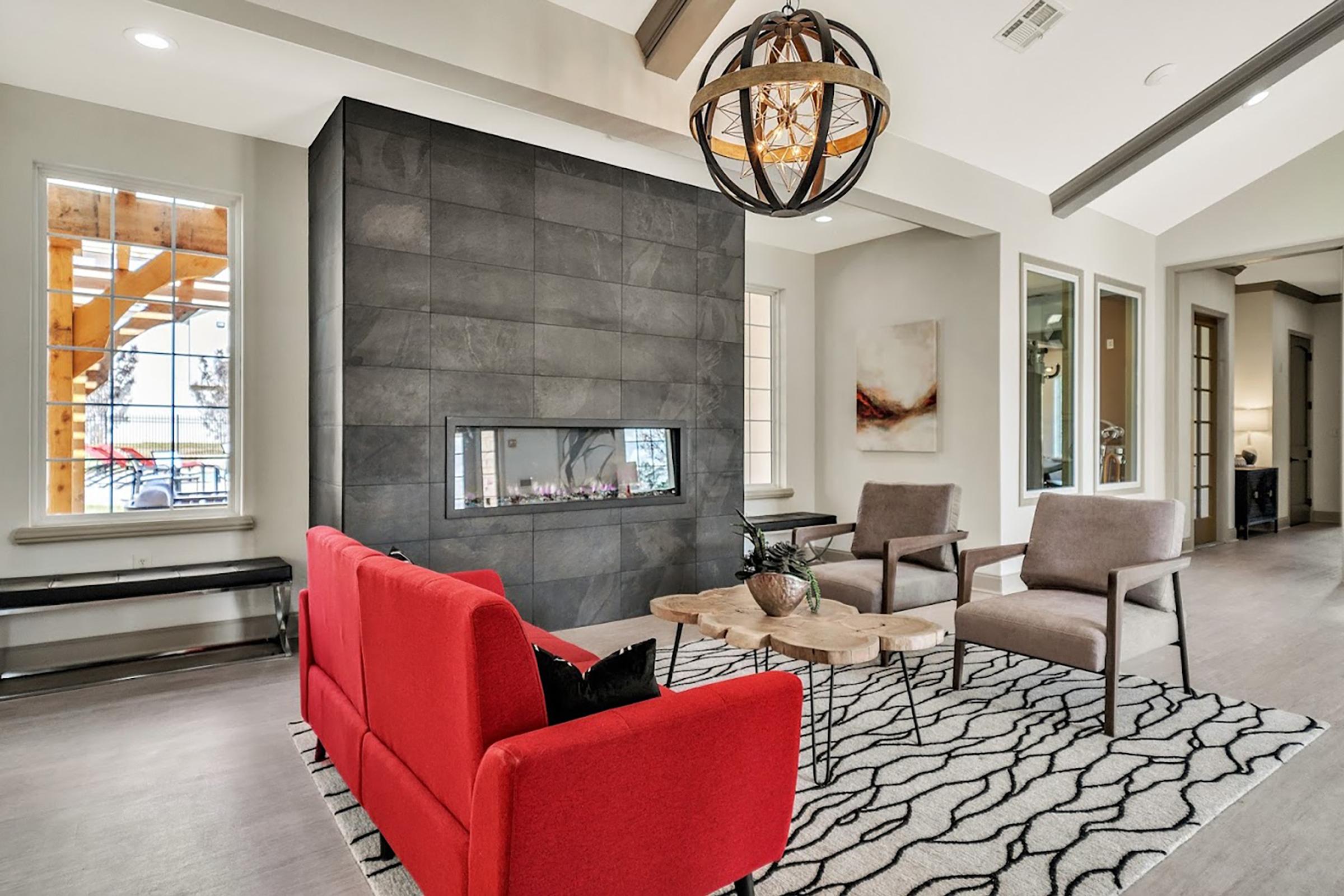 a living room filled with furniture and a large window