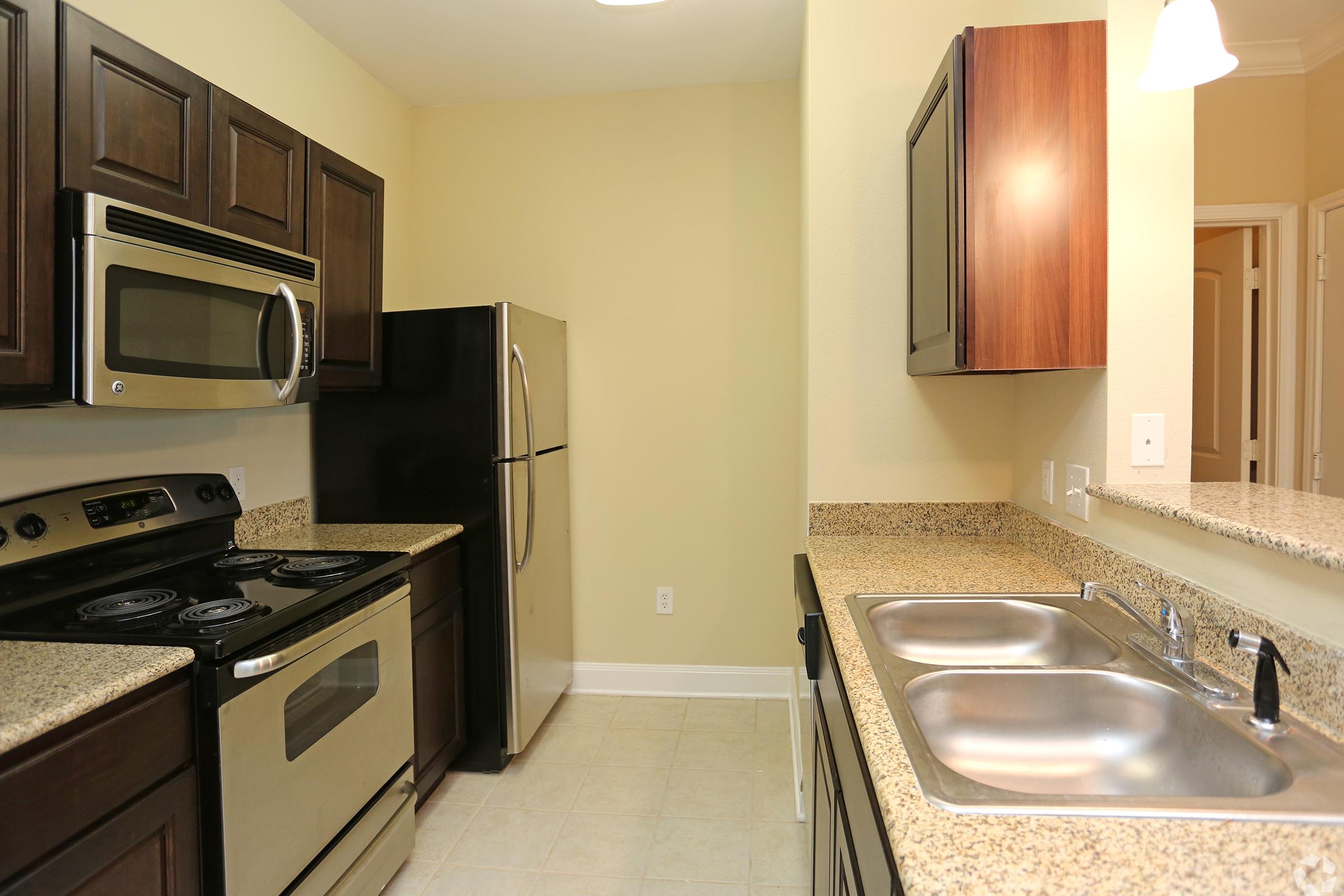 a kitchen with a stove a sink and a microwave