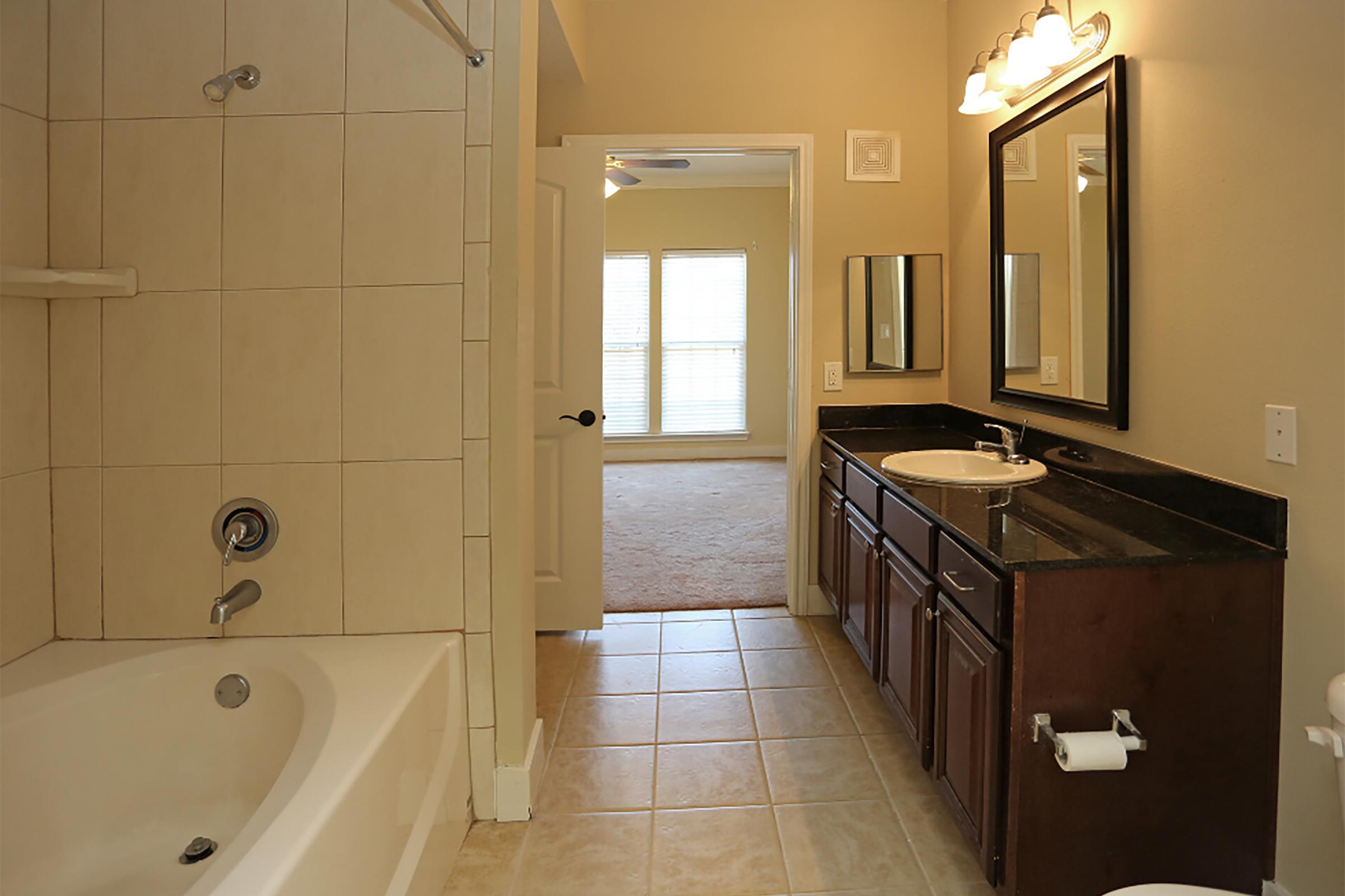 a large tub next to a sink