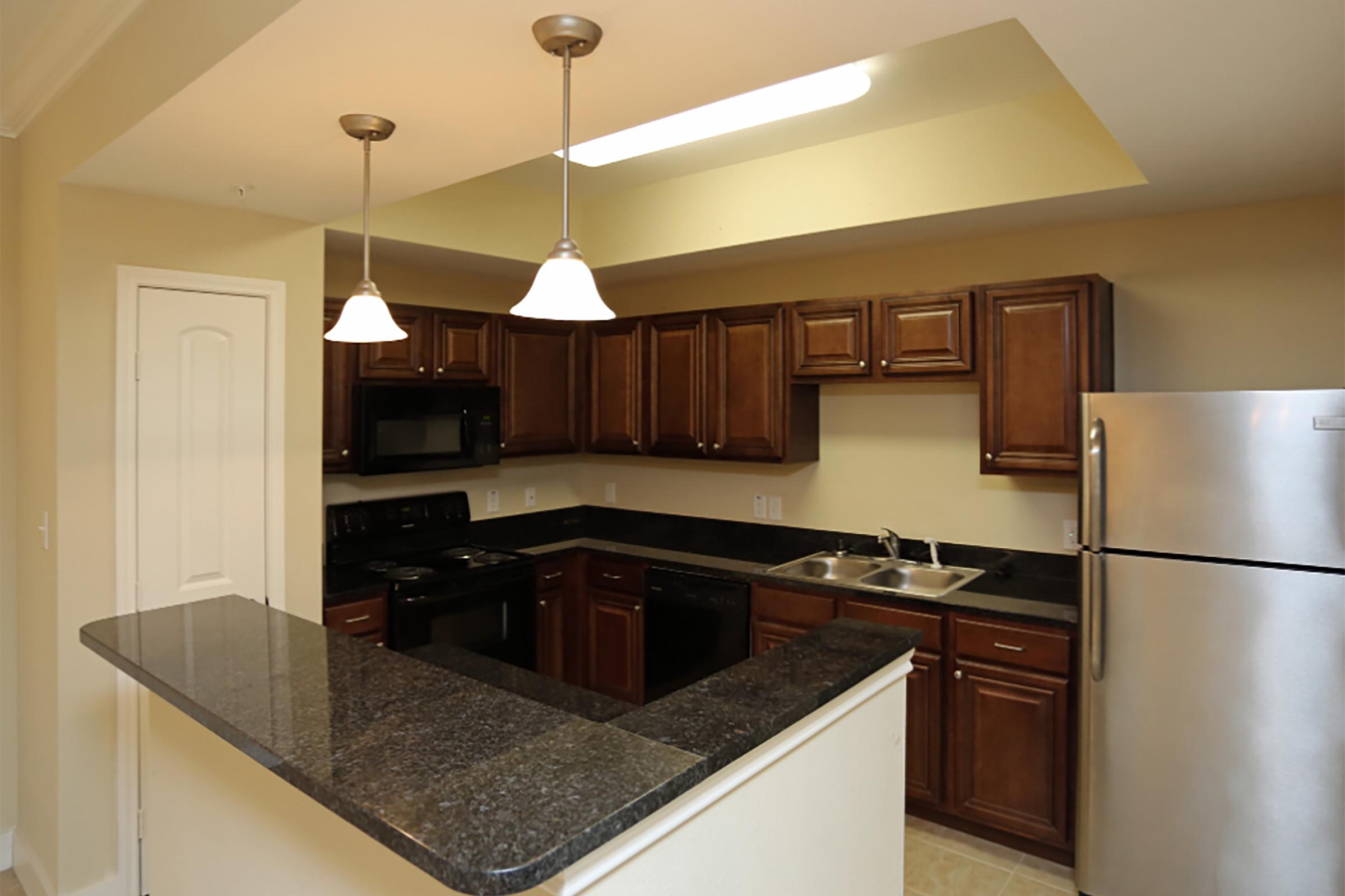 a modern kitchen with stainless steel appliances and wooden cabinets