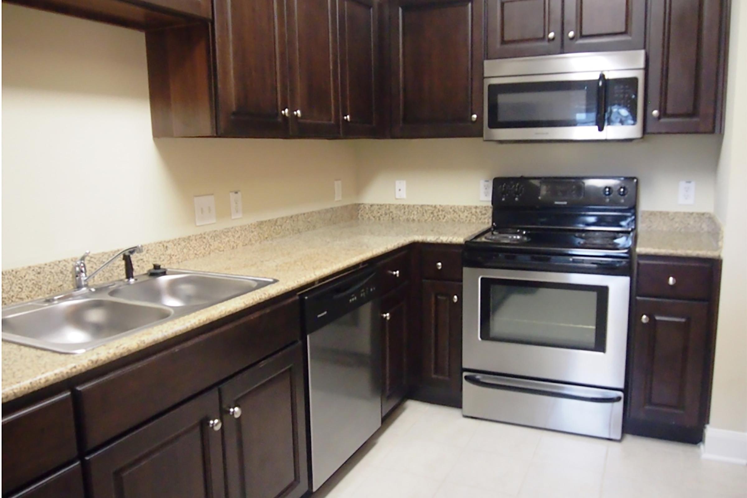 a kitchen with stainless steel appliances and wooden cabinets