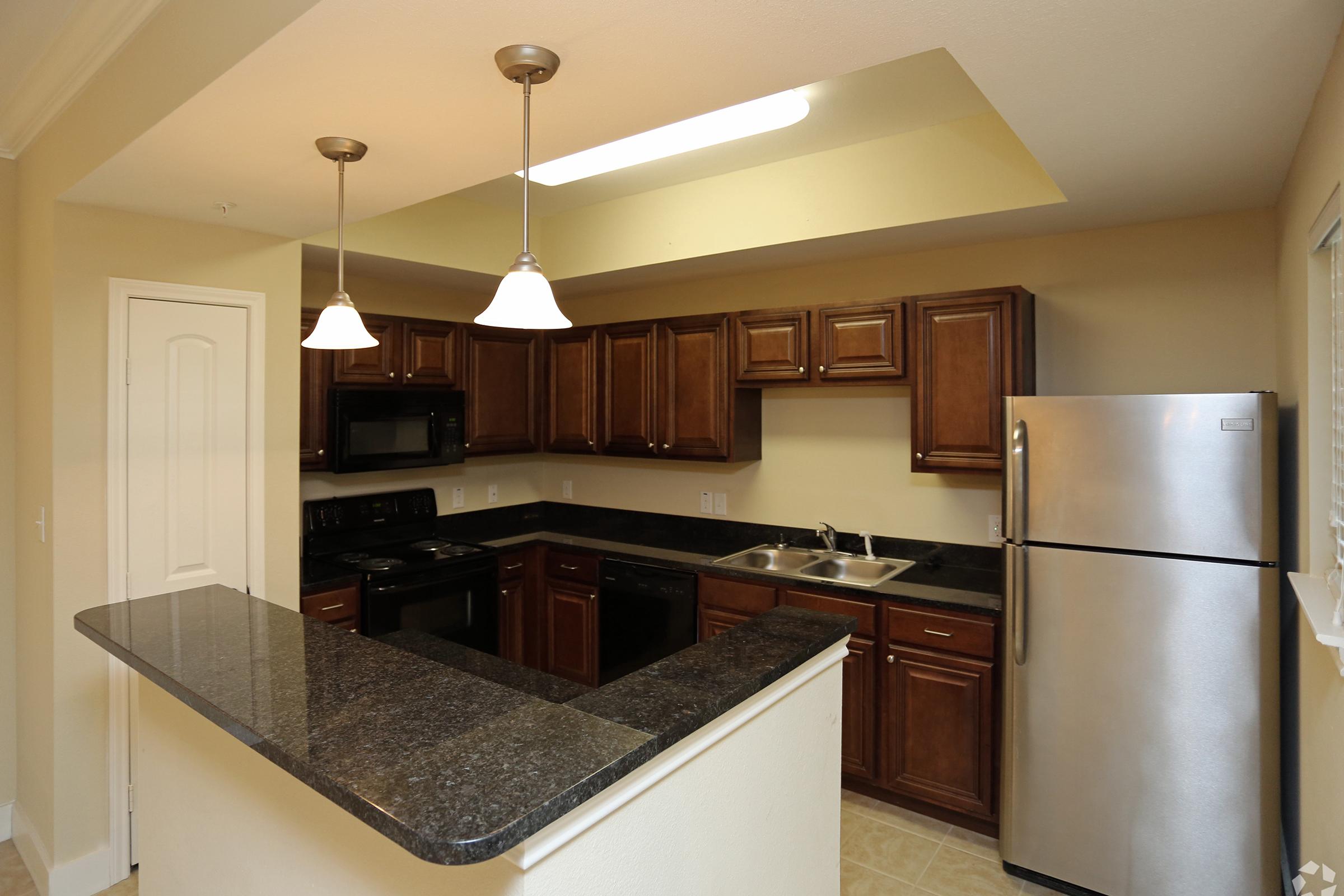 a modern kitchen with stainless steel appliances and wooden cabinets