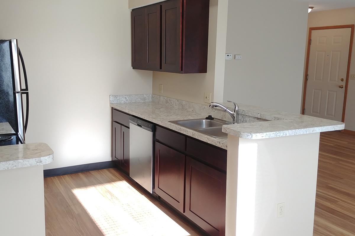 a kitchen with a sink and a refrigerator