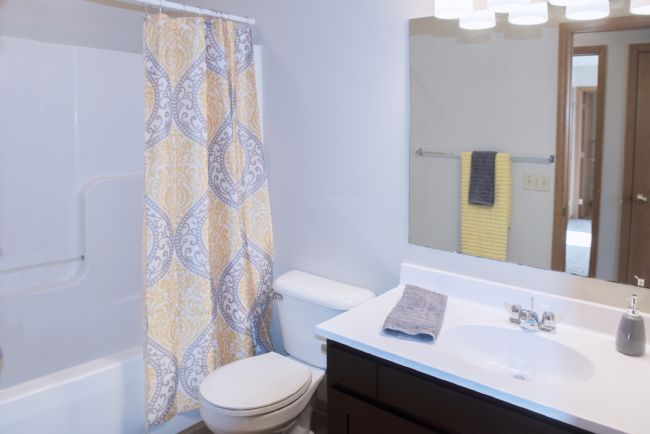 a white tub sitting next to a sink